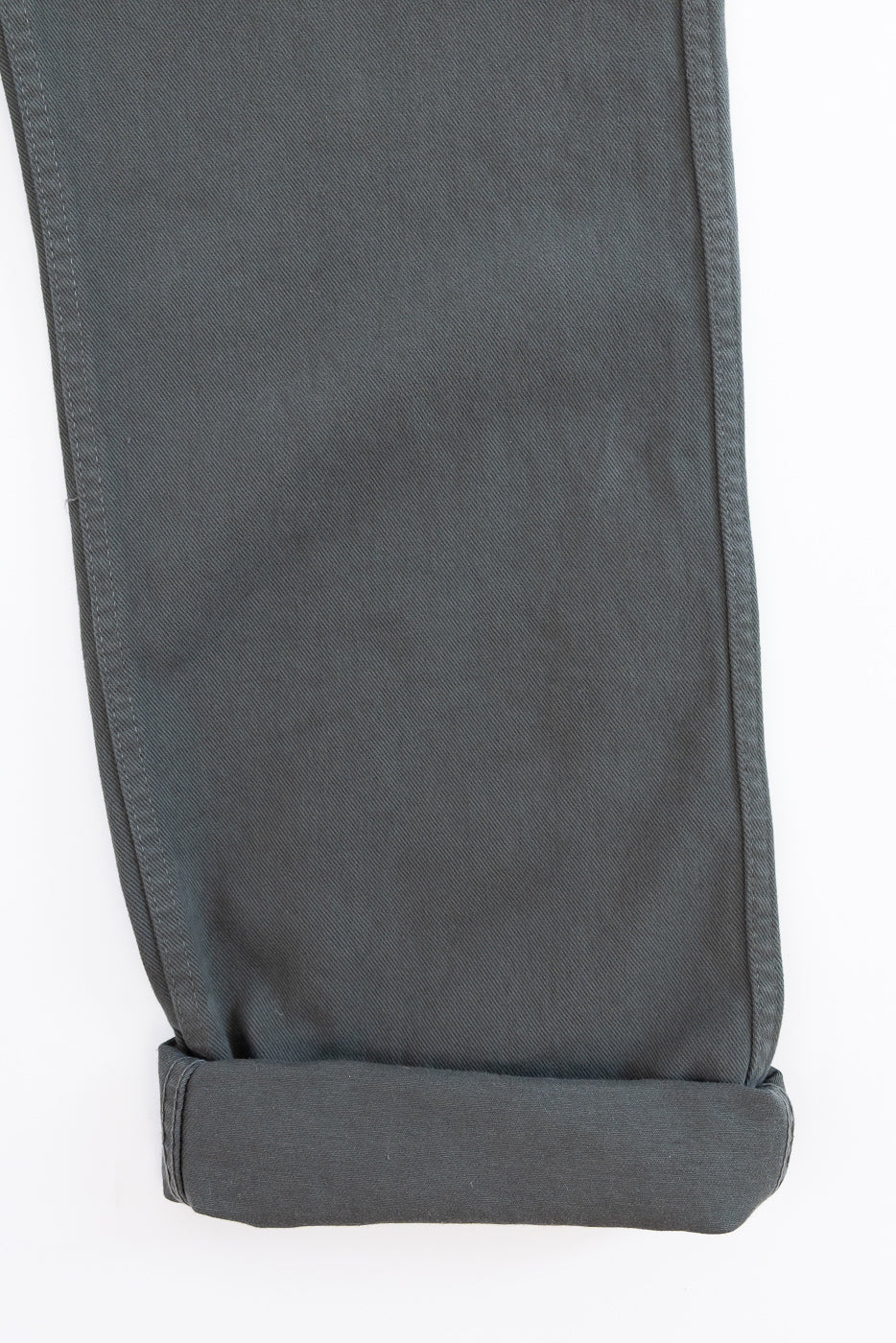 Close-up of gray pants with a white background