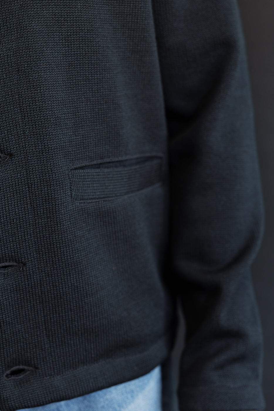 close up of pocket of black cardigan