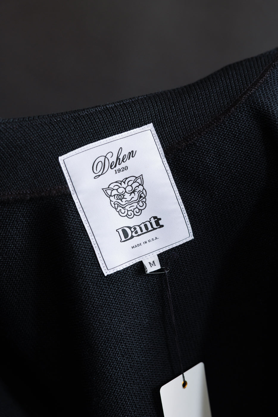 Close up of woven label with dehen 1920 and dant collaboration logos