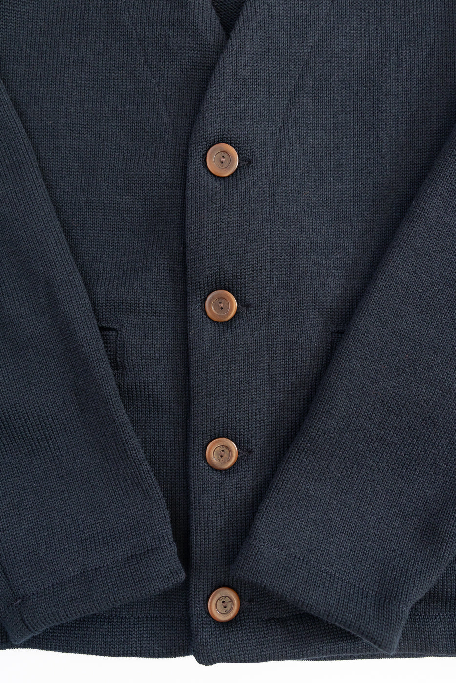 Black Dant slouchy cardigan with brown buttons on a white background, close up on 4 brown buttons
