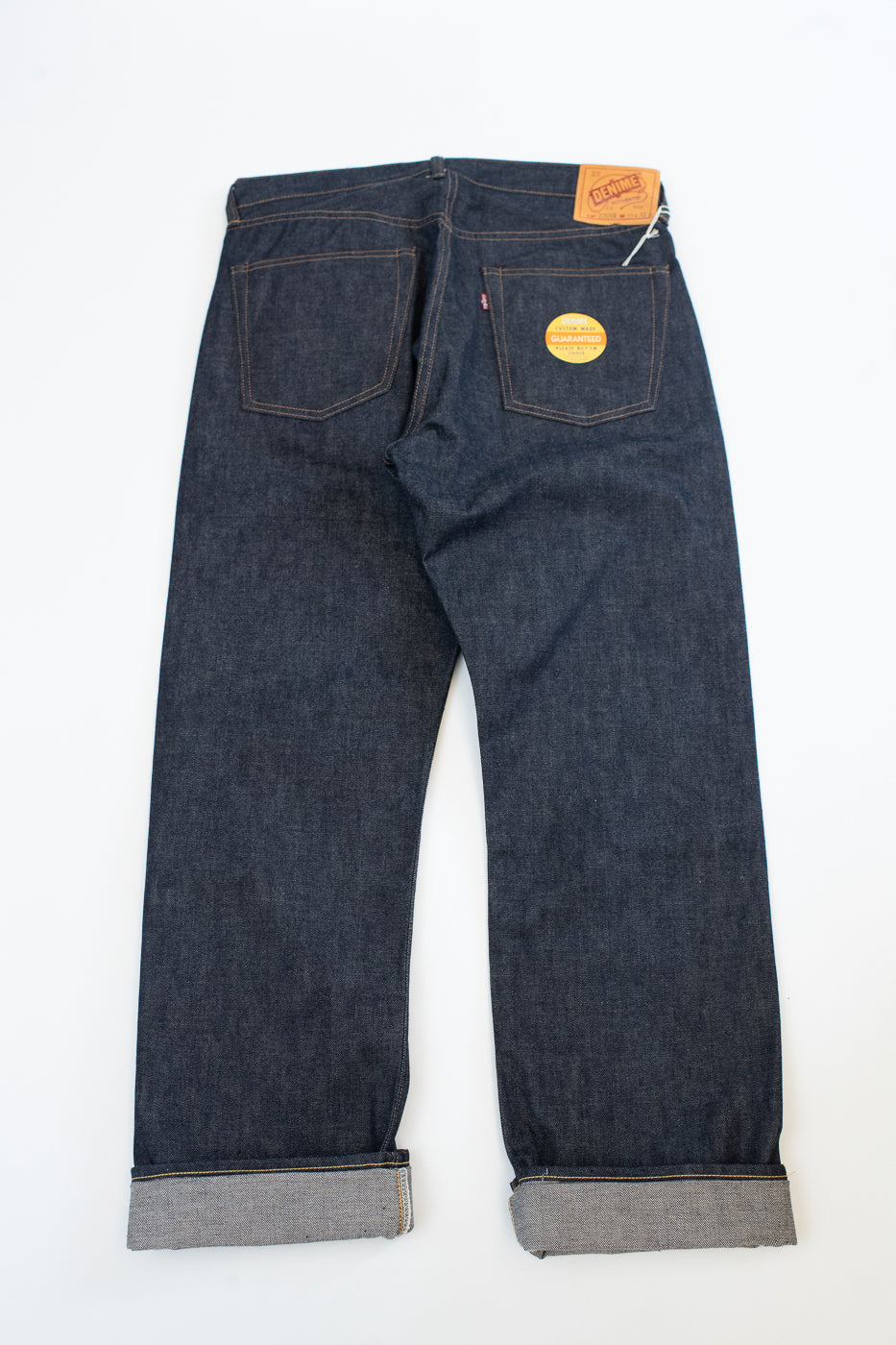 Pair of dark blue jeans on a white background