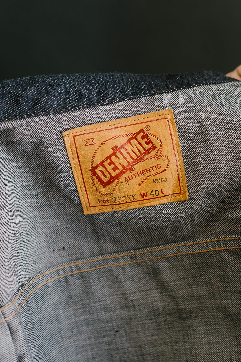 Denim label on a jacket with a dark background
