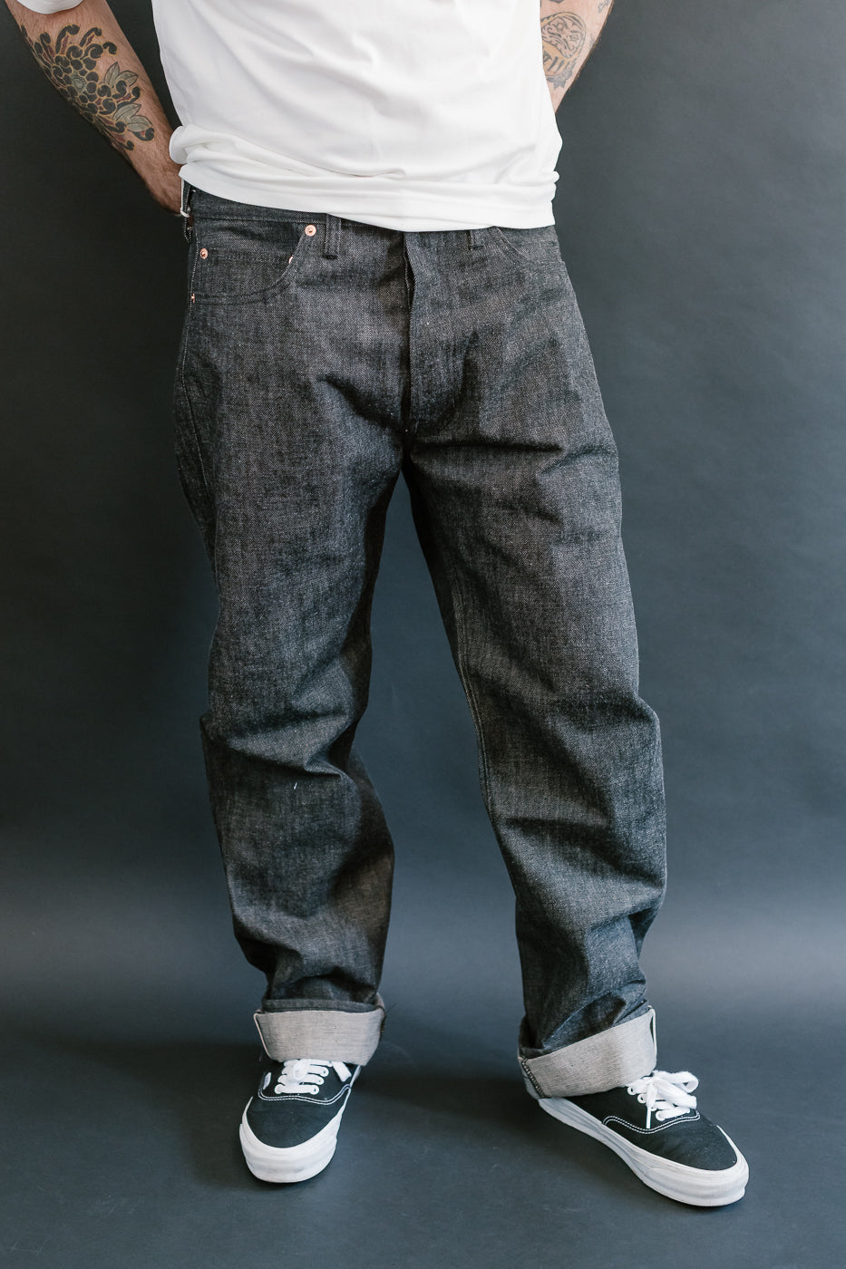 man wearing denime black mother cotton denim jeans 3/4 view, front