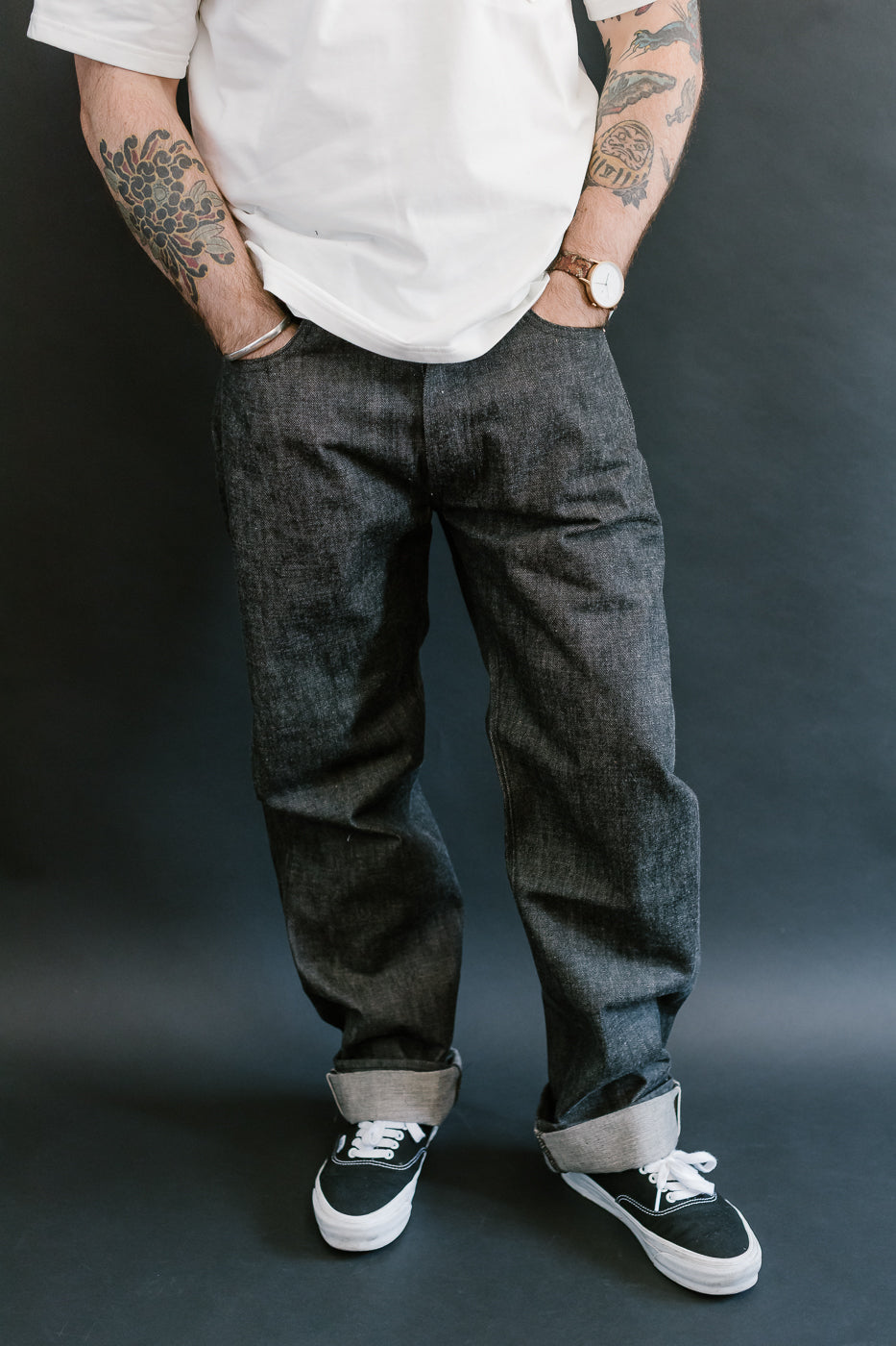 man wearing denime black mother cotton denim jeans 3/4 view, front