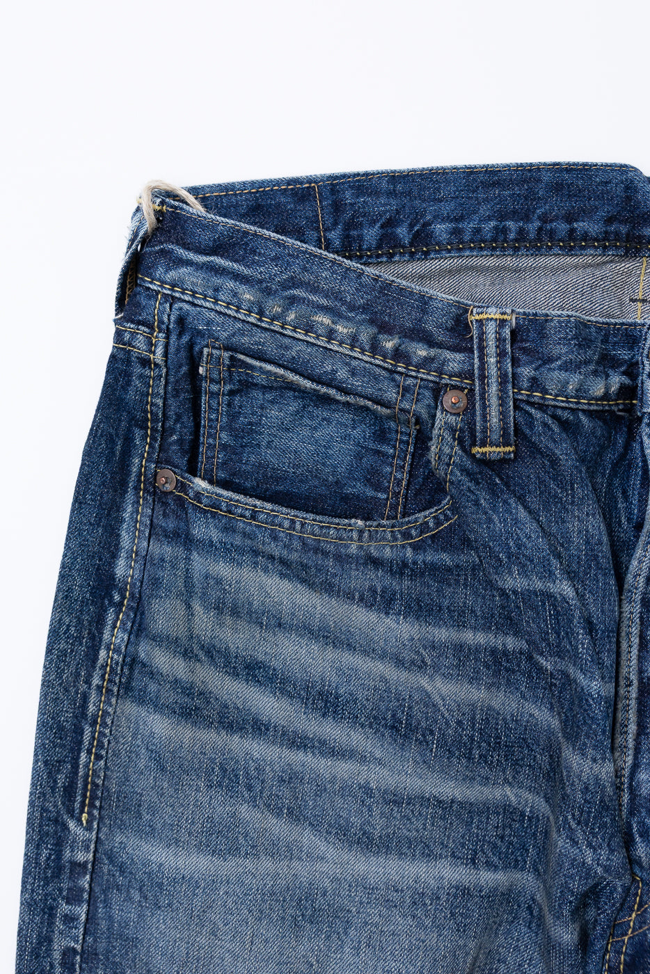 Heavily Washed indigo denim layflat with a 2