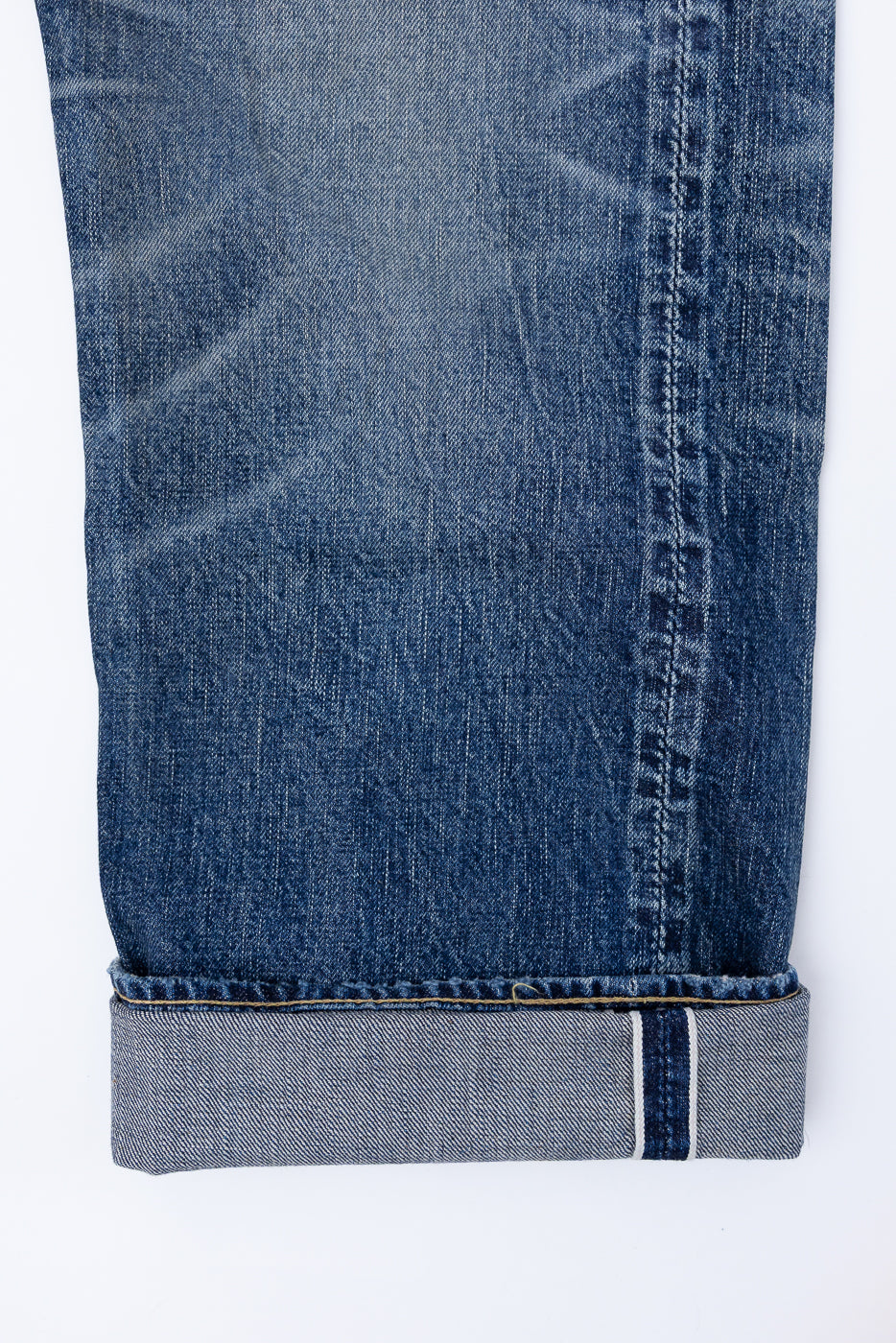Heavily Washed indigo denim layflat with a 2