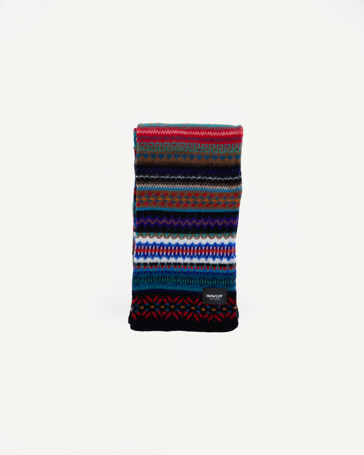 multicolored, patterned wool scarf with a black base on a white background