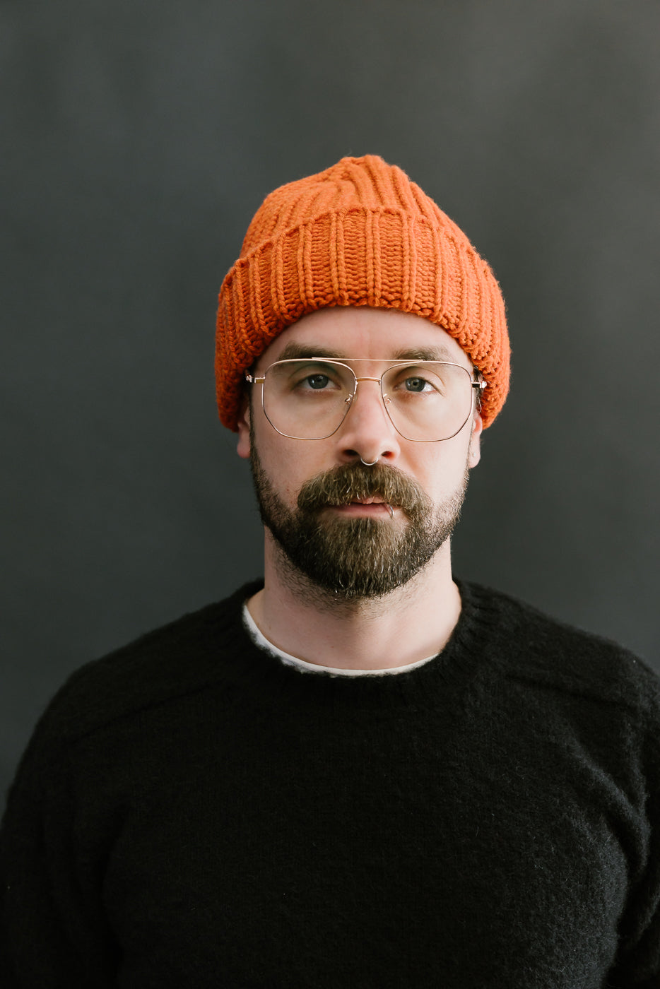 safety orange ribbed chunky beanie, watch cap on bearded mans head, front view