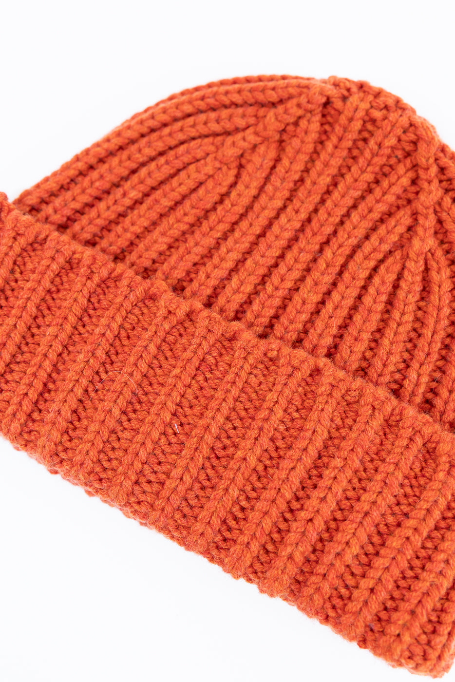 close up safety orange ribbed chunky beanie, watch cap on white background