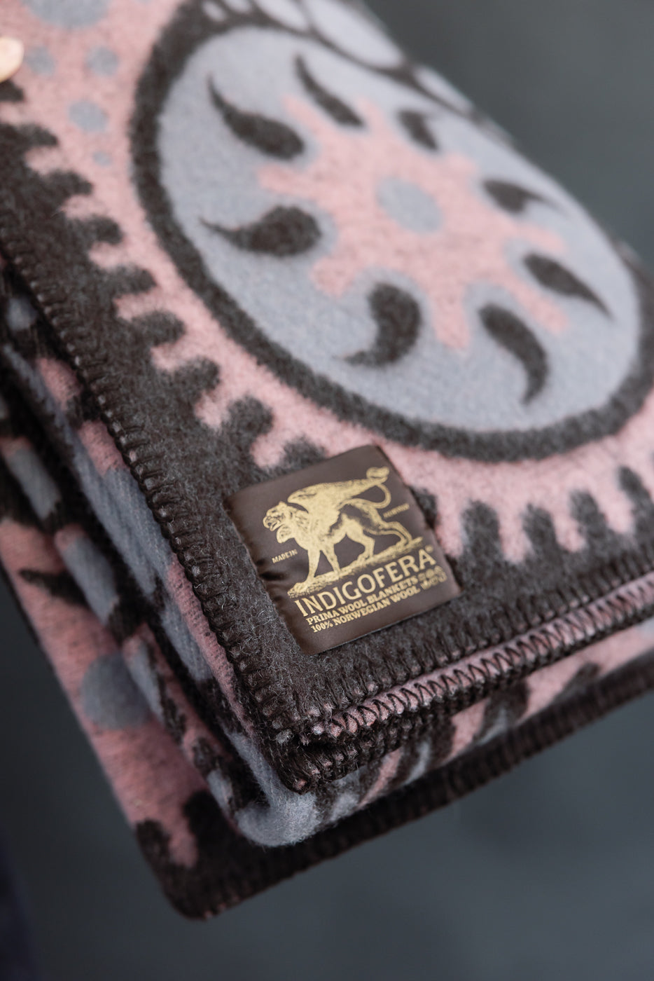 Close-up of the tag on the pink and black blanket