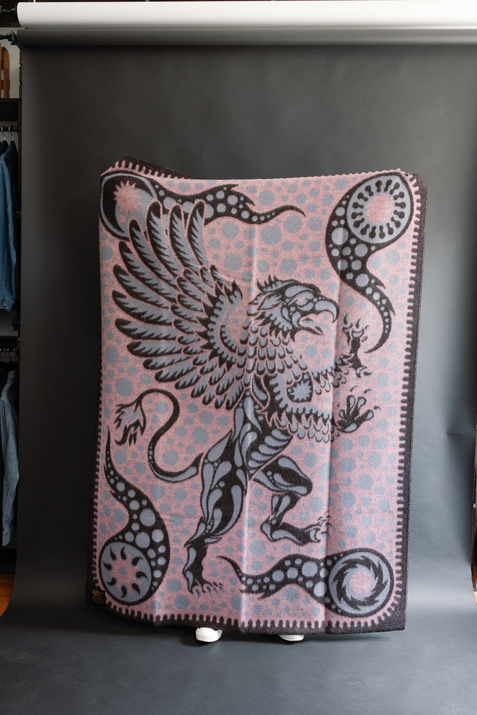 fully open pink blanket with grypon, wings, and bubble pattern, front