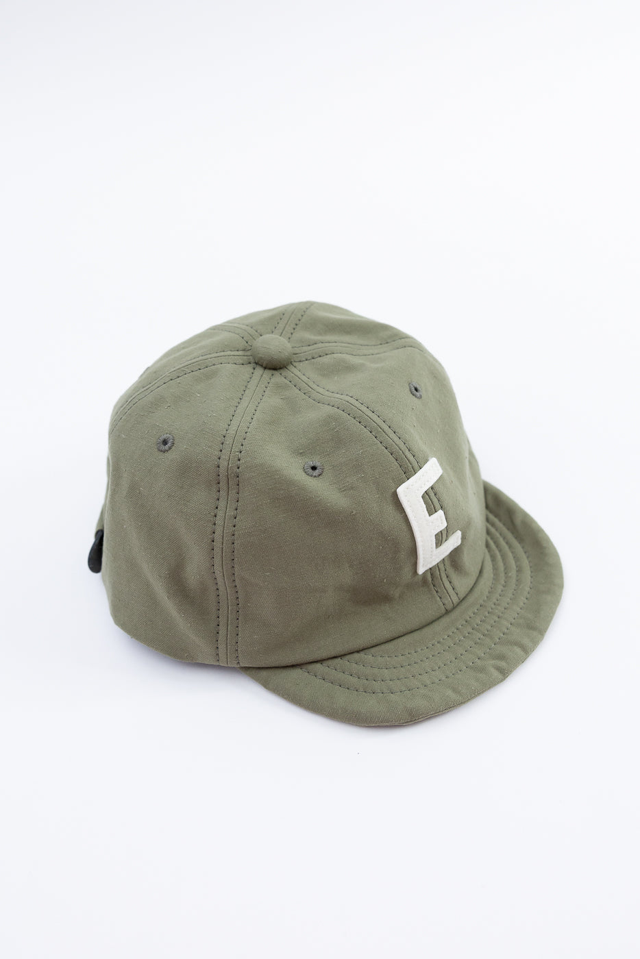 Green cap with a white logo on a white background