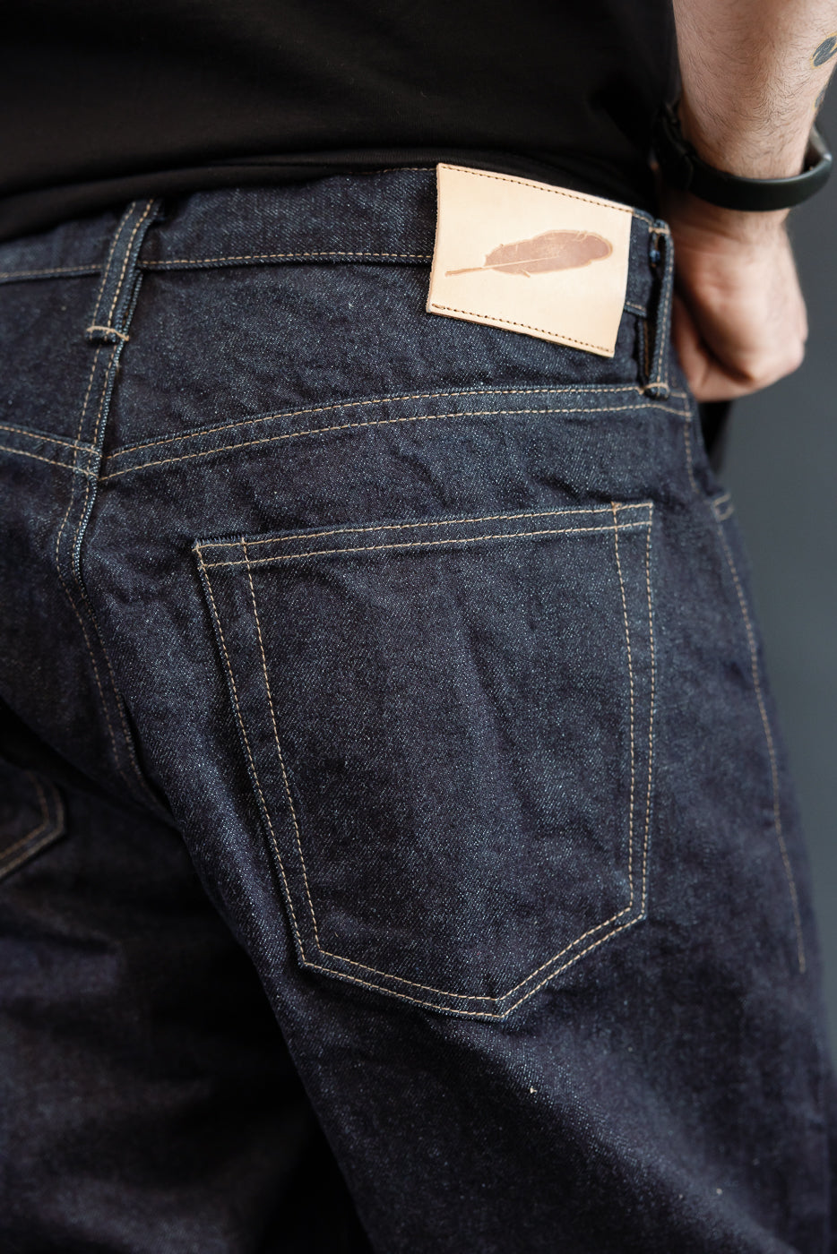 close up of RGT 15oz rinsed selvedge, back pocket, veg tan leather patch