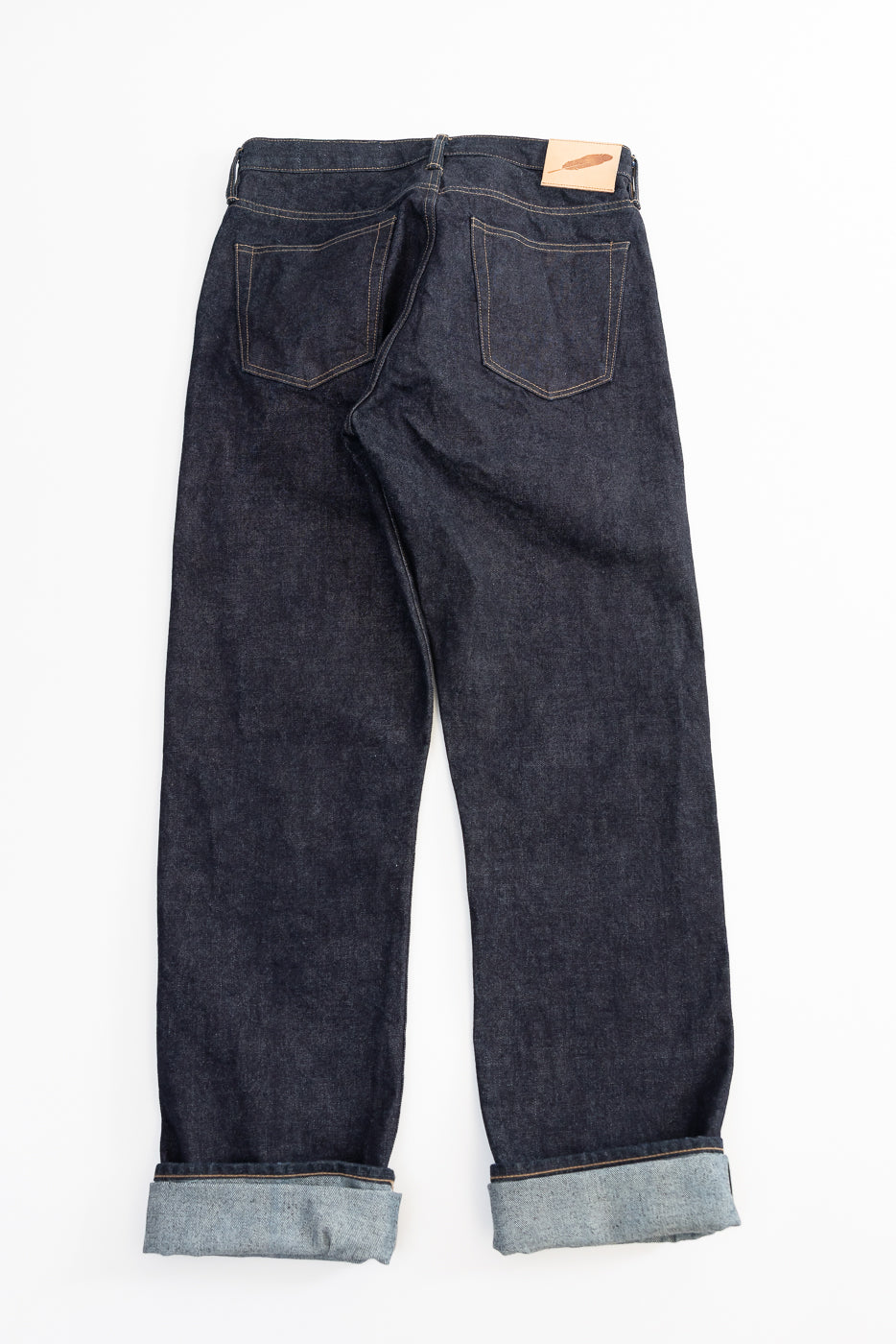 Back view Pair of dark blue jeans on a white background