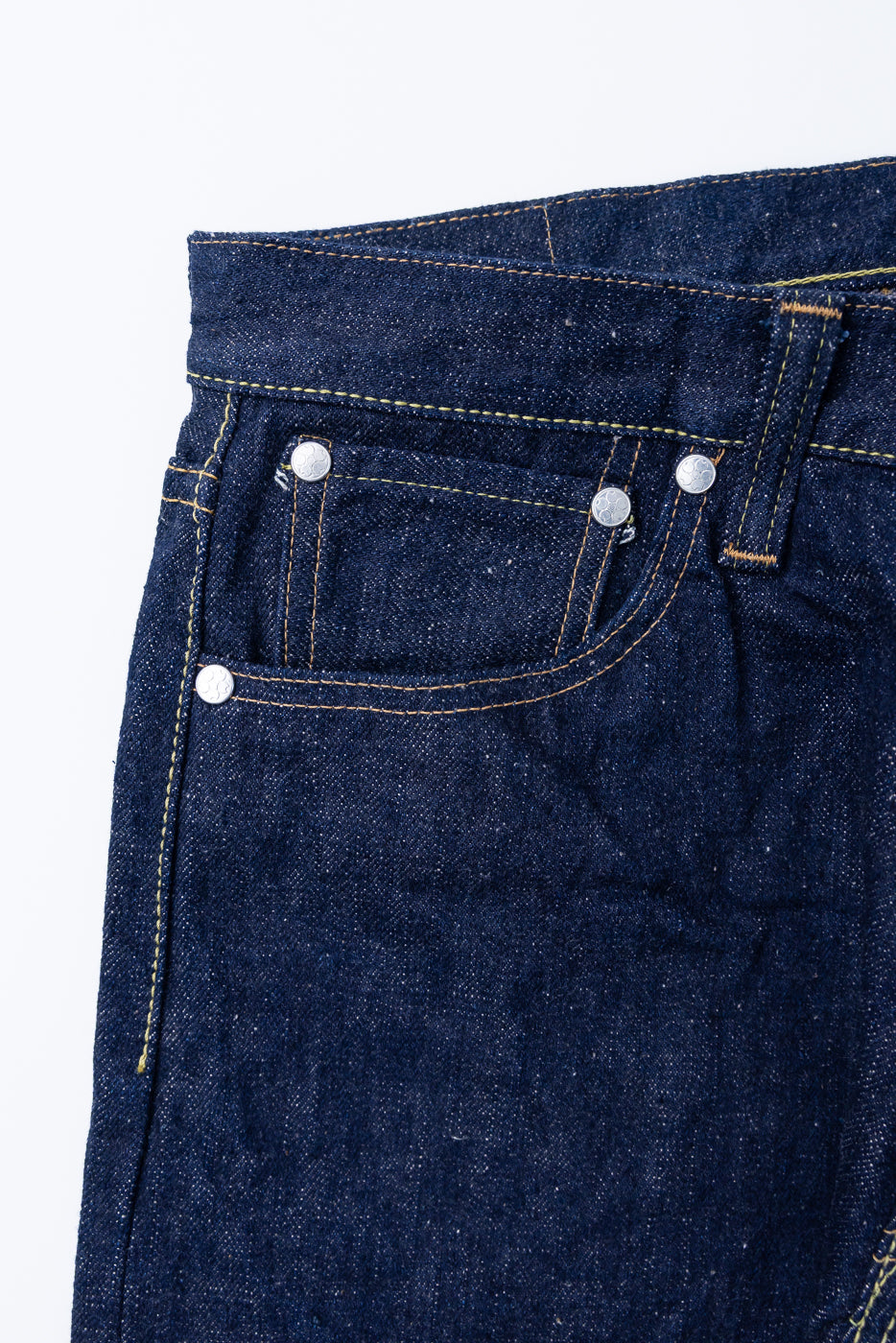 Close-up of S500AX-SAKURA jeans waistband, showing belt loop, rivets, and coin pocket, made from 18oz AI-PLUS denim with sakura-dyed weft.