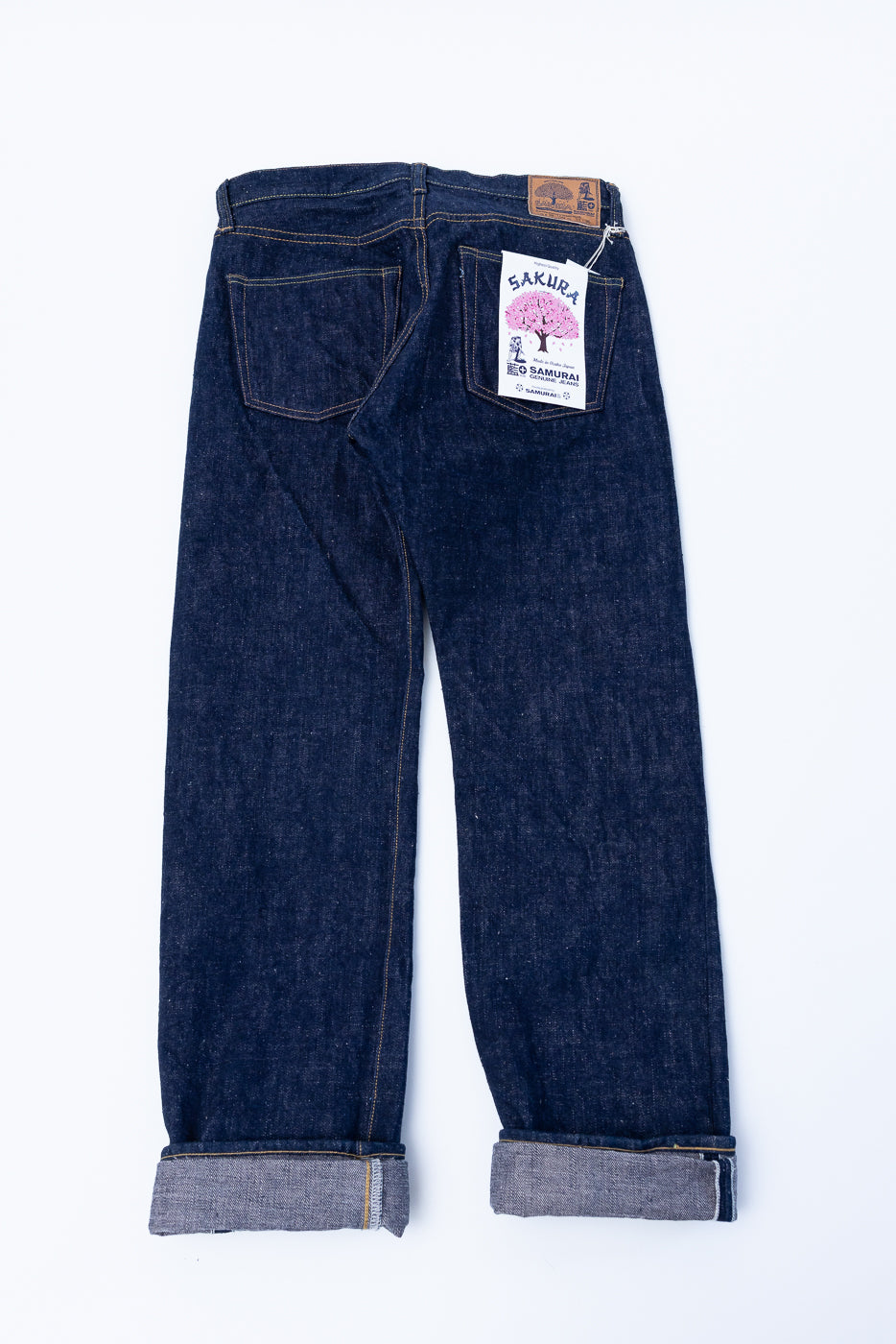 S500AX-SAKURA - 18oz Ai-Plus-Sakura Selvedge Jeans with selvedge edge, sakura motif buttons, and a leather patch, showcasing intricate Japanese denim craftsmanship.