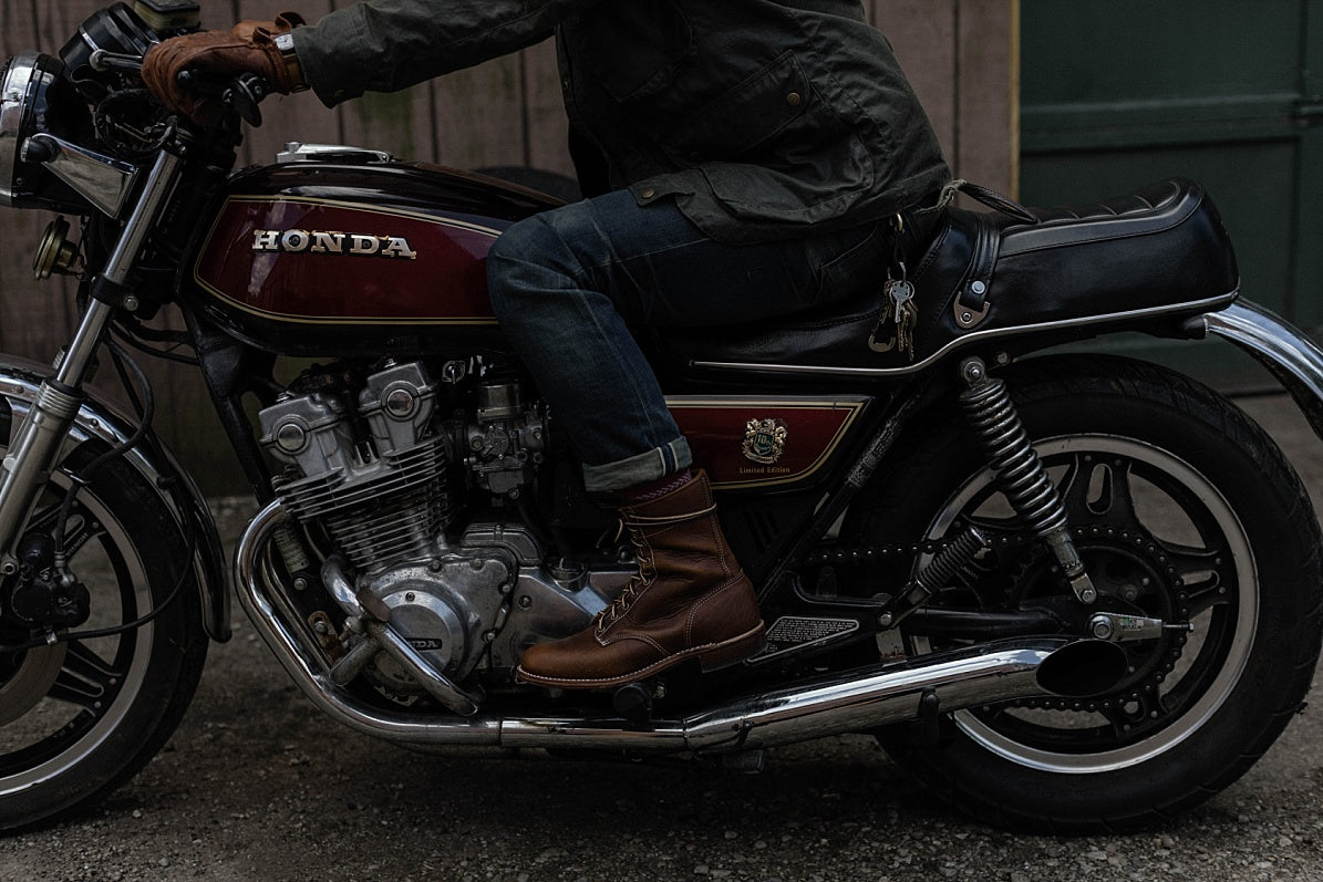 Man in casual apparel and boots sitting on vintage Honda motorcycle, Dant style inspiration