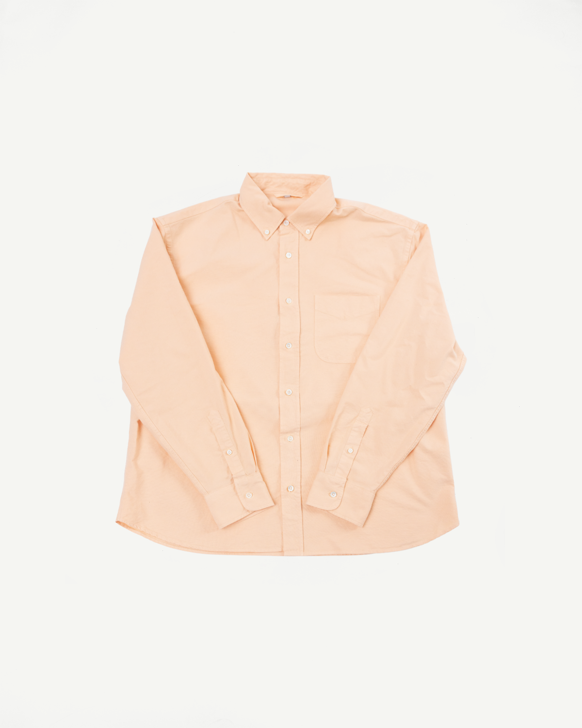 Peach button-down shirt flat lay, front view, long sleeves, chest pocket, button cuffs
