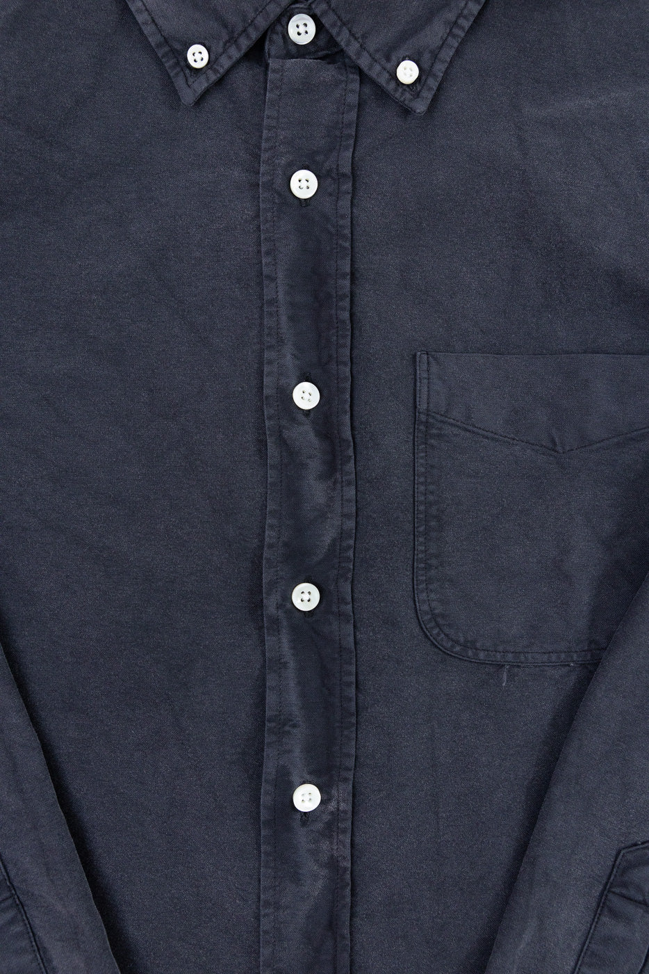 Close-up of vintage black Oxford cotton shirt front, button-down collar, chest pocket, white buttons