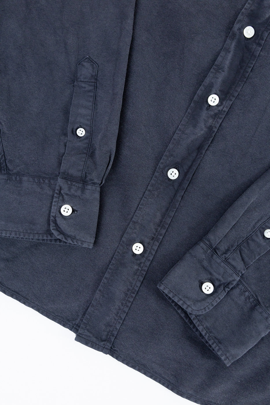 Close-up of 3sixteen Big Oxford vintage black shirt front, showing white buttons, fabric texture, and cuff details.