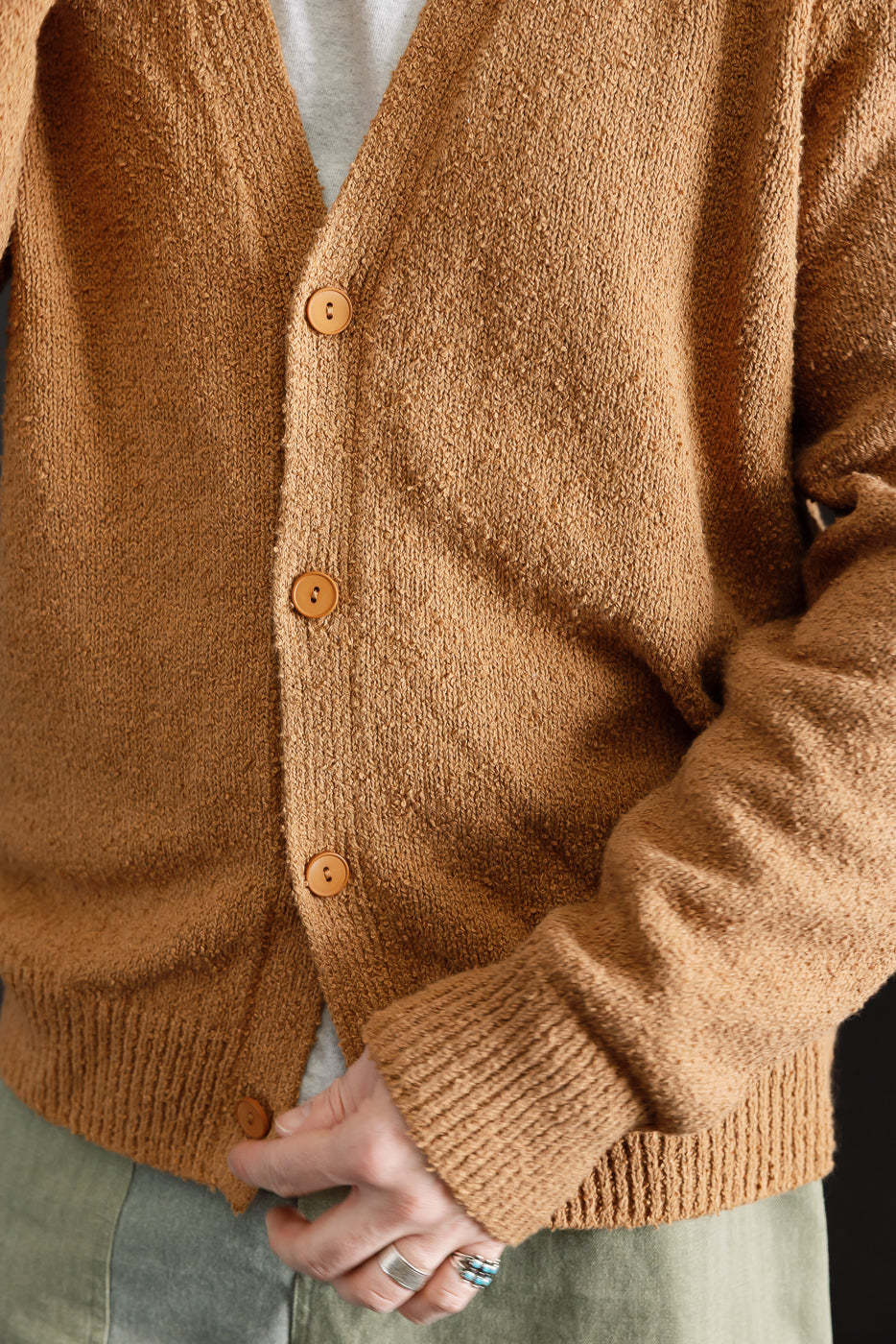 Close-up front view of ochre boucle cardigan on male model 5'9