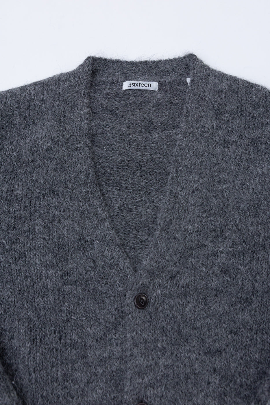 Close-up front view of a grey 3sixteen cardigan showing fabric texture, V-neck, and button.