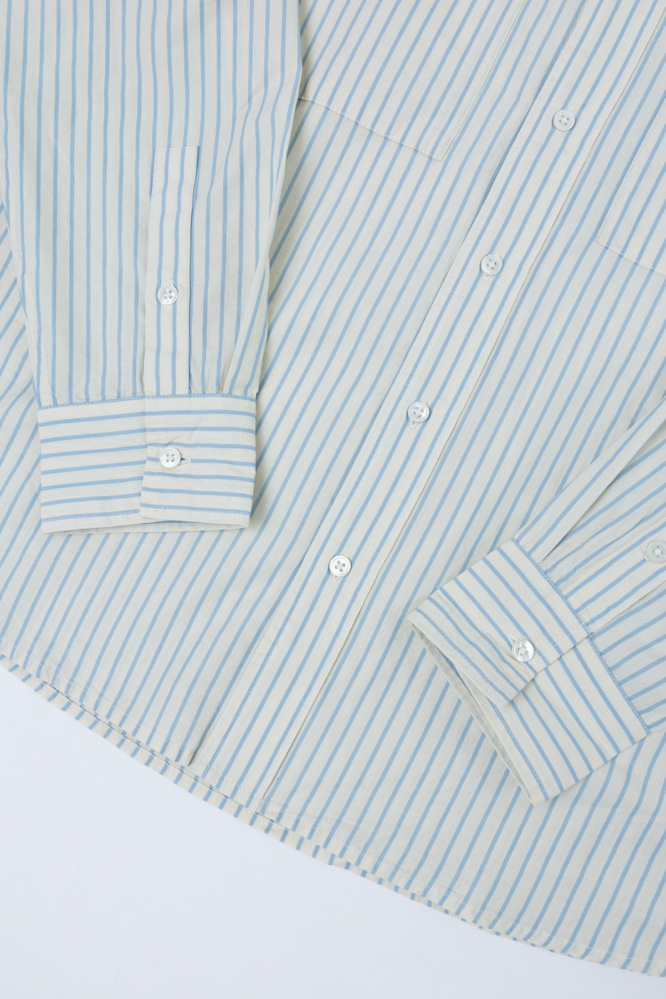 Flat lay front view of a light blue and white striped long-sleeve button-down shirt.
