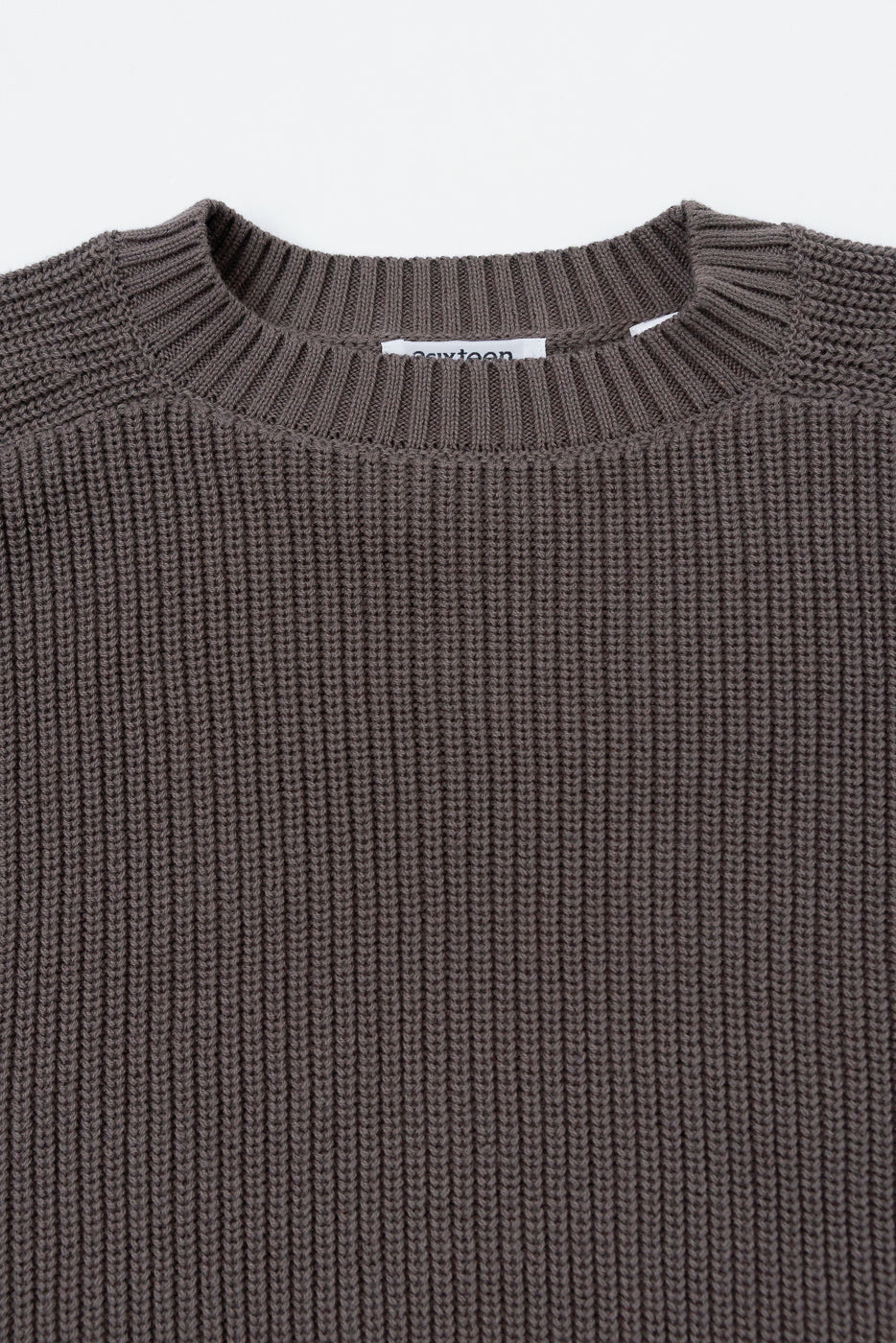 Close-up front view of a brown ribbed knit sweater showing the crew neckline and fabric texture.