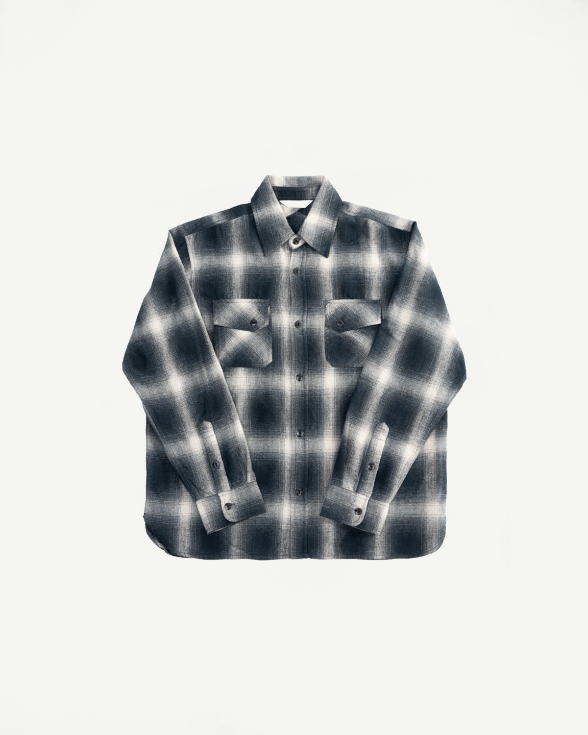 Flat lay, front view of black ombre plaid flannel shirt with button pockets and spread collar.