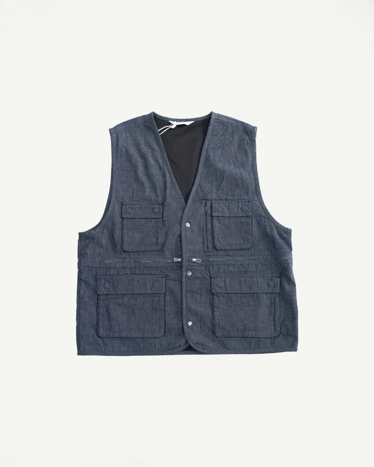 Flat lay front view of indigo ripstop field vest, four flap pockets, snap buttons, v-neck.
