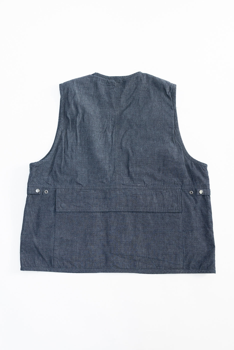 Flat lay of indigo ripstop field vest back, showing rear panels and back pocket details.