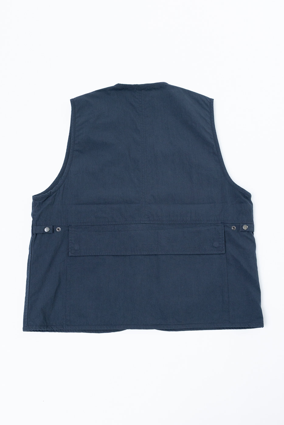 Back view flat lay of a navy blue utility vest showing the rear pocket and hem.