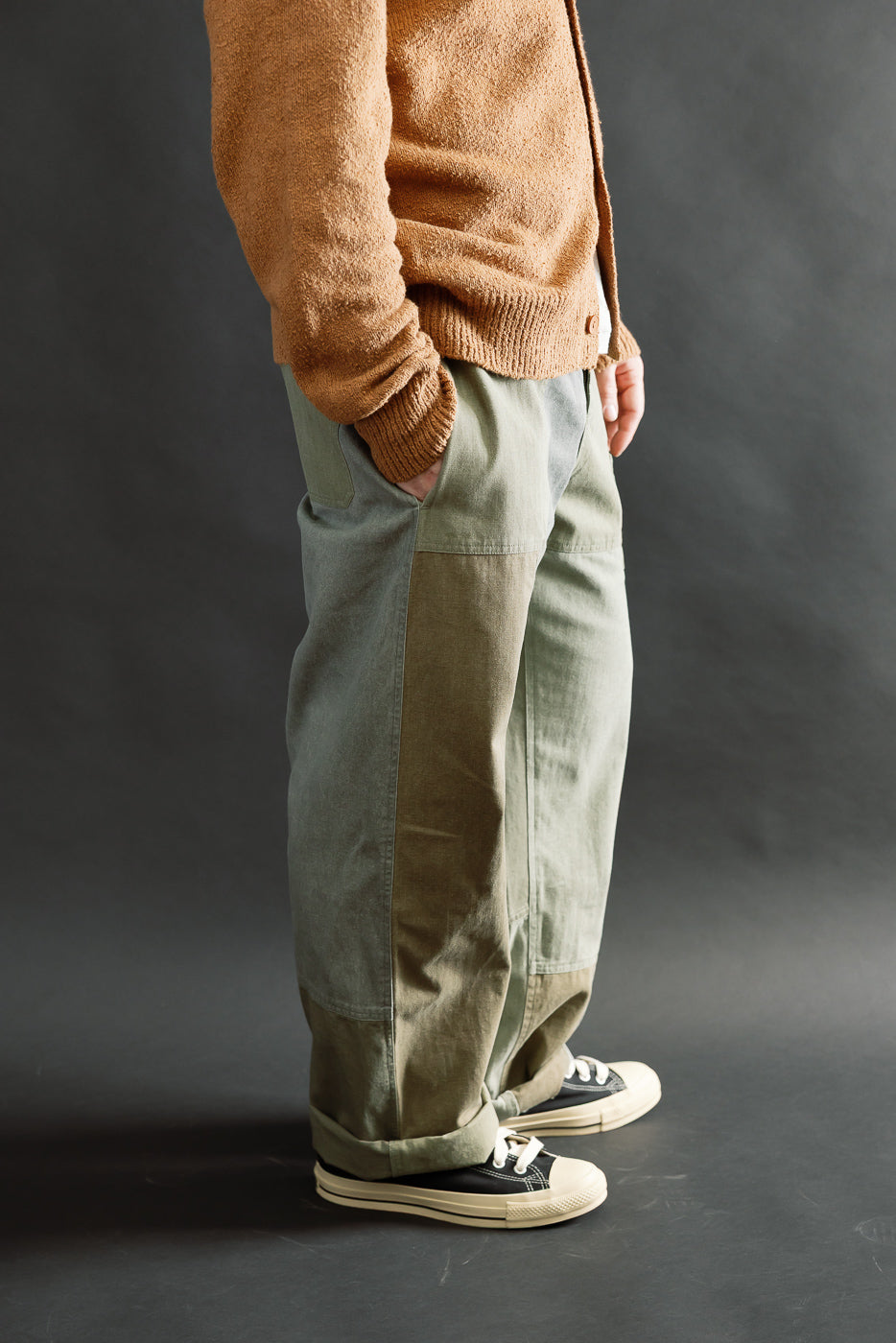 Side view close-up of olive patchwork pants on male model 5'9