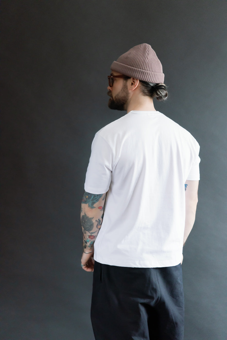 Full body back view of male model 5'9 165lbs athletic build wearing white boxy t-shirt