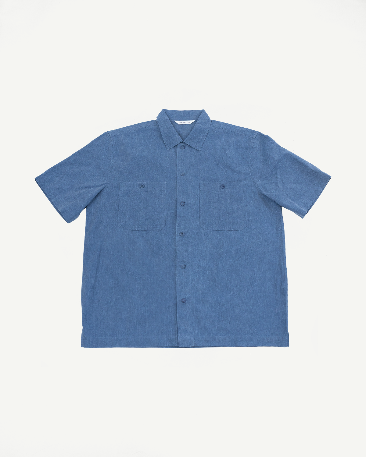 Short Sleeve Work Shirt - Blue Pigment Dye, featuring a classic point collar, button-up front, and dual cut-corner chest pockets, crafted from vintage-washed 100% cotton with Corozo button detailing.