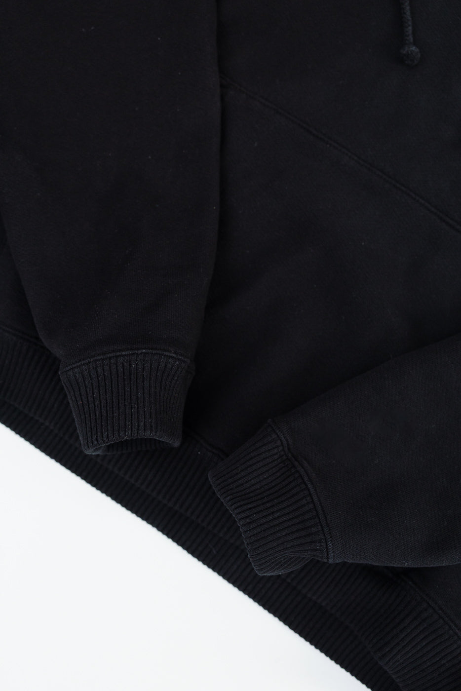 Close-up of 3sixteen black ultraweight pullover hoodie front cuffs and hem, ribbed details
