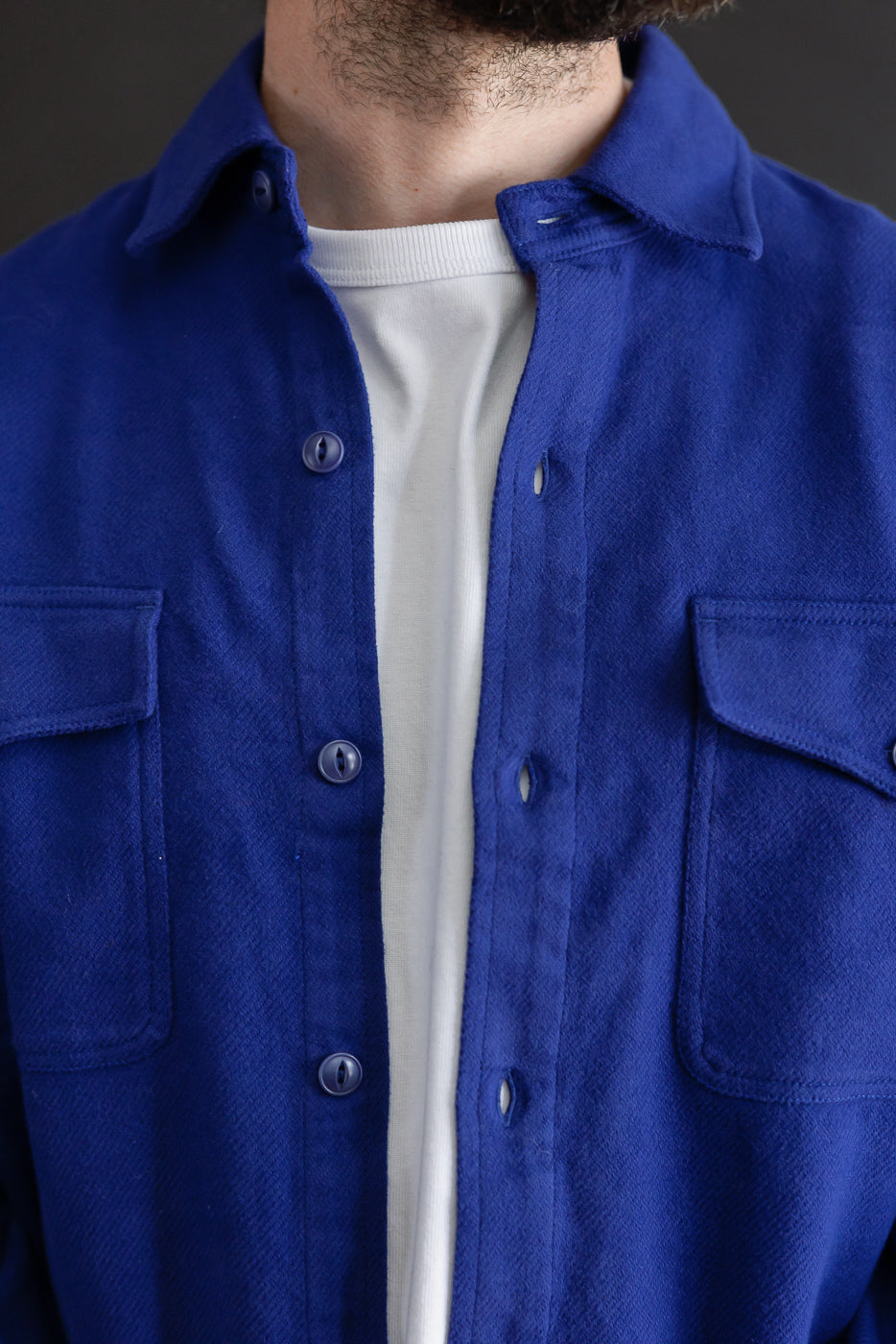 Close-up front view of a blue textured shirt on a male model, 5'9