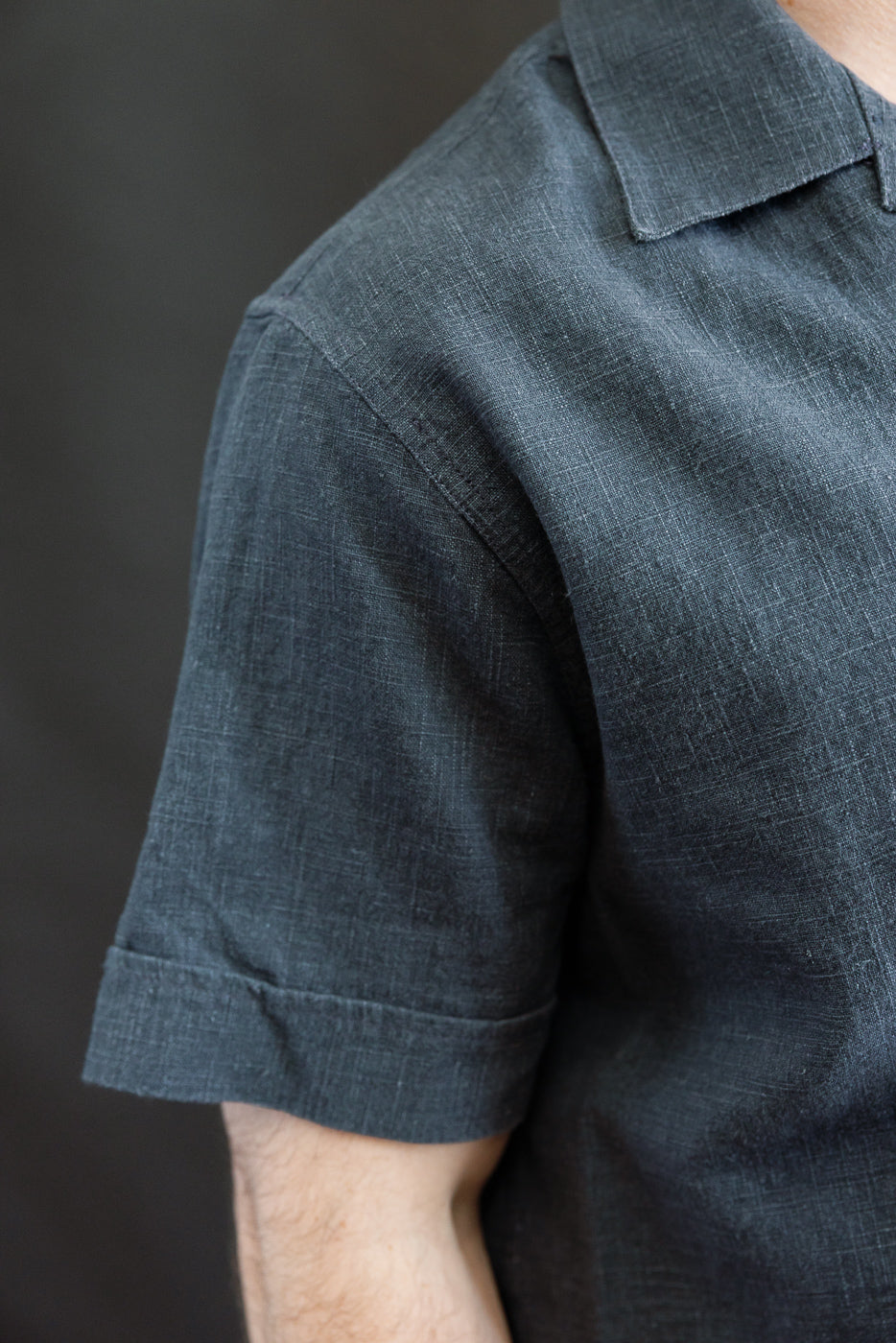 Close-up of the 3sixteen Vacation Shirt - Blue Linen, showcasing its textured linen fabric, rolled-hem sleeve, and open-collar design, embodying a vintage-inspired yet modern, relaxed fit.