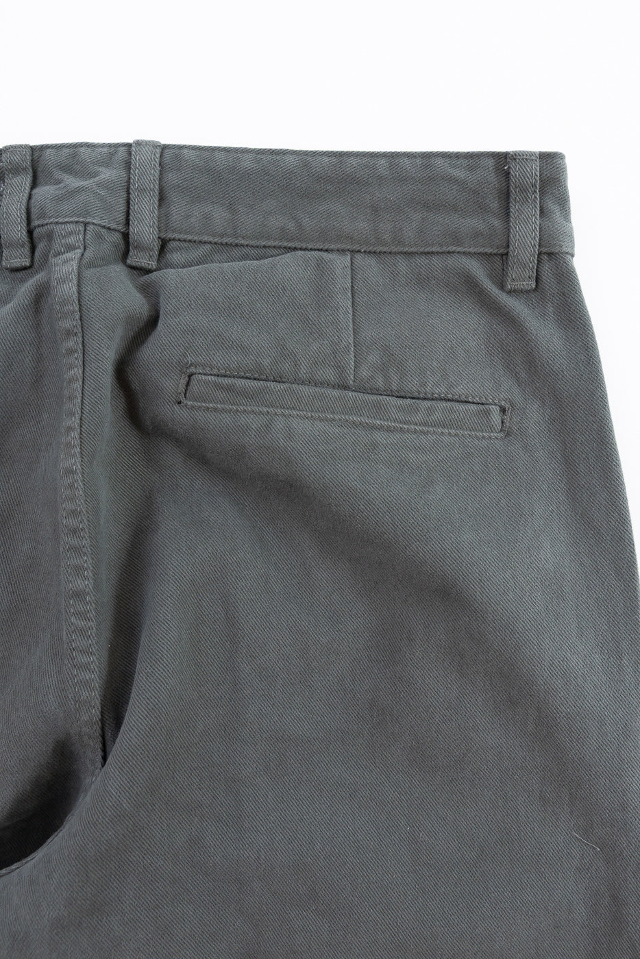 Close-up of gray pants with a pocket on a white background