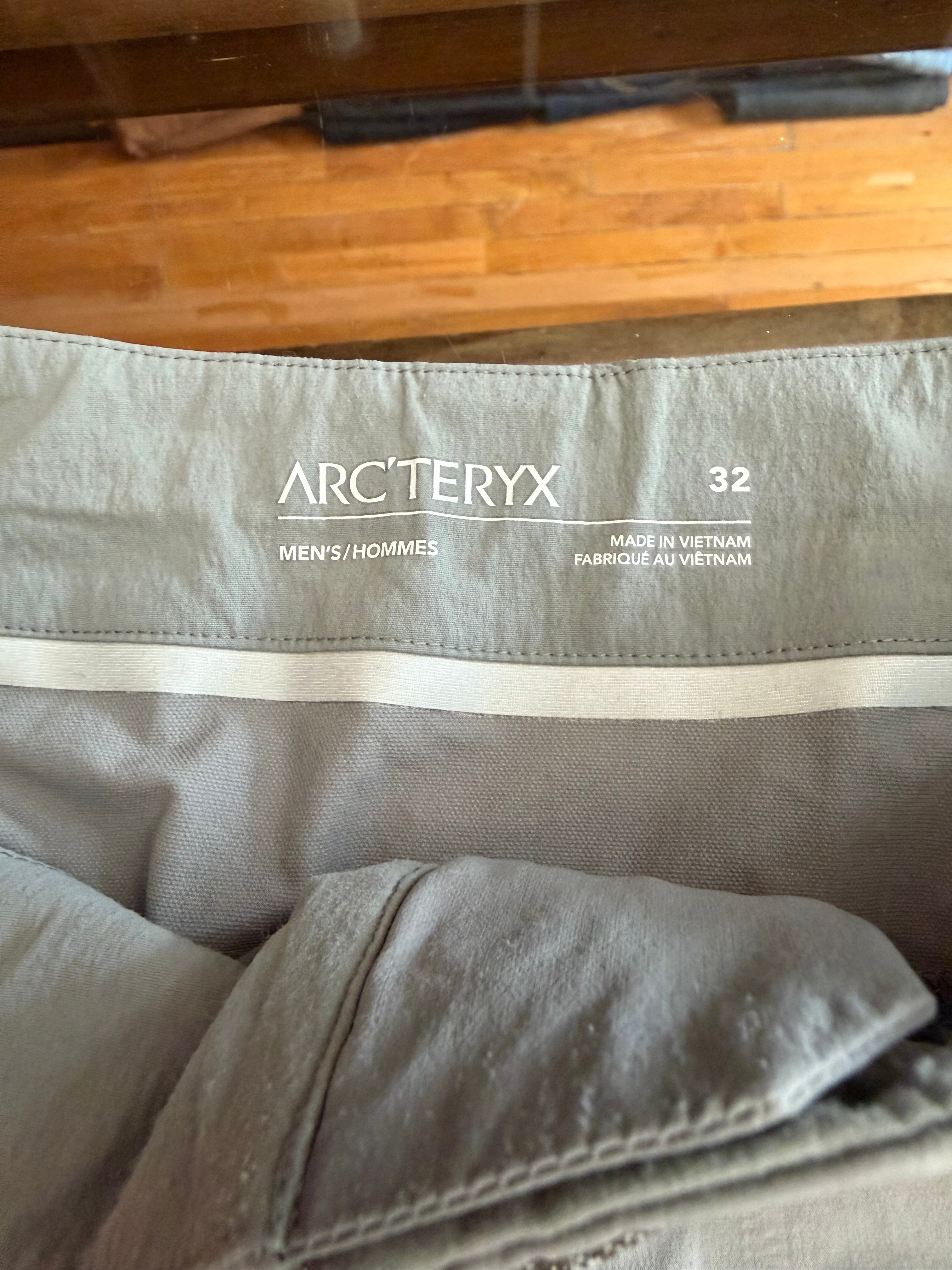 Close-up of men's Arc'teryx size 32 tag, showing brand, size, and 'Made in Vietnam' details on gray garment interior.