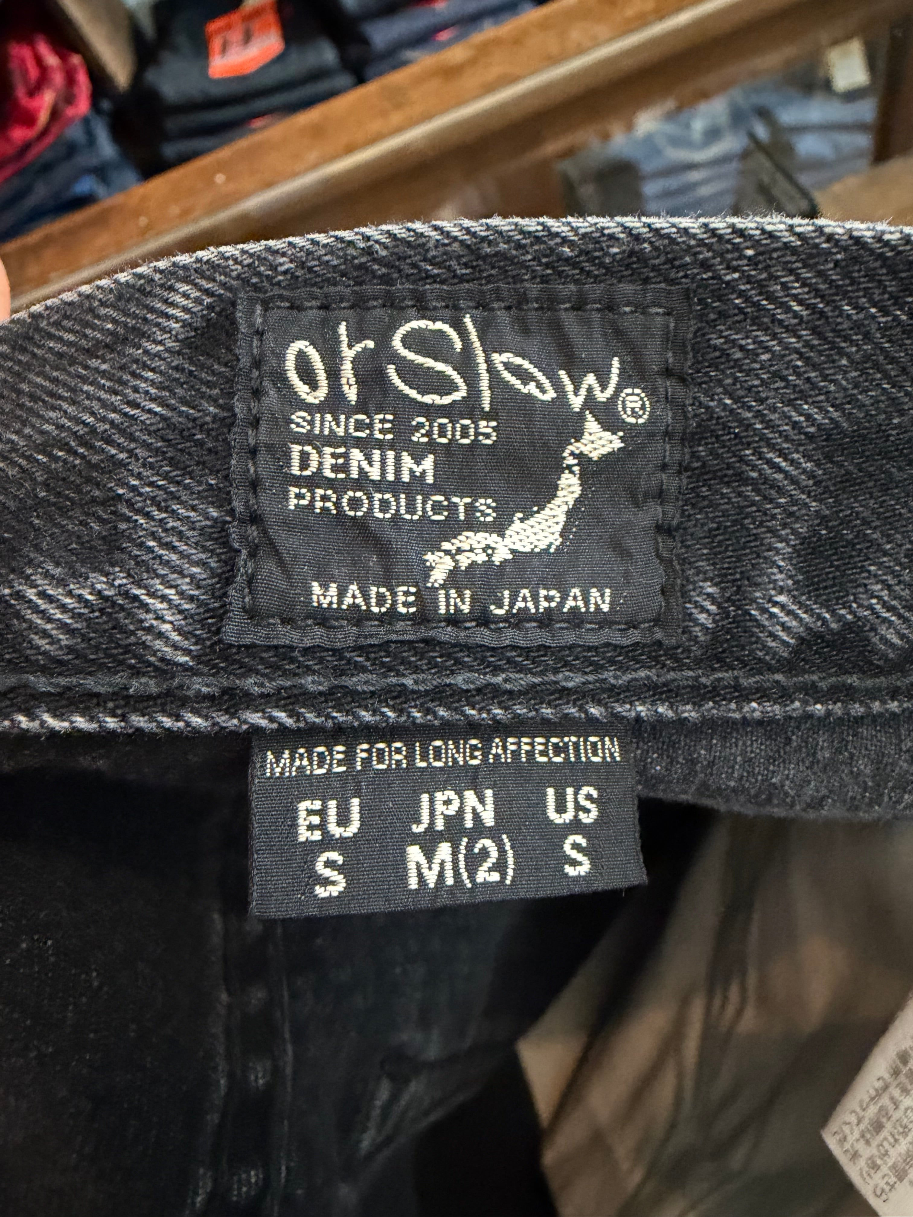 Close-up of orSlow denim jeans inner label showing brand, sizing, and Made in Japan tag