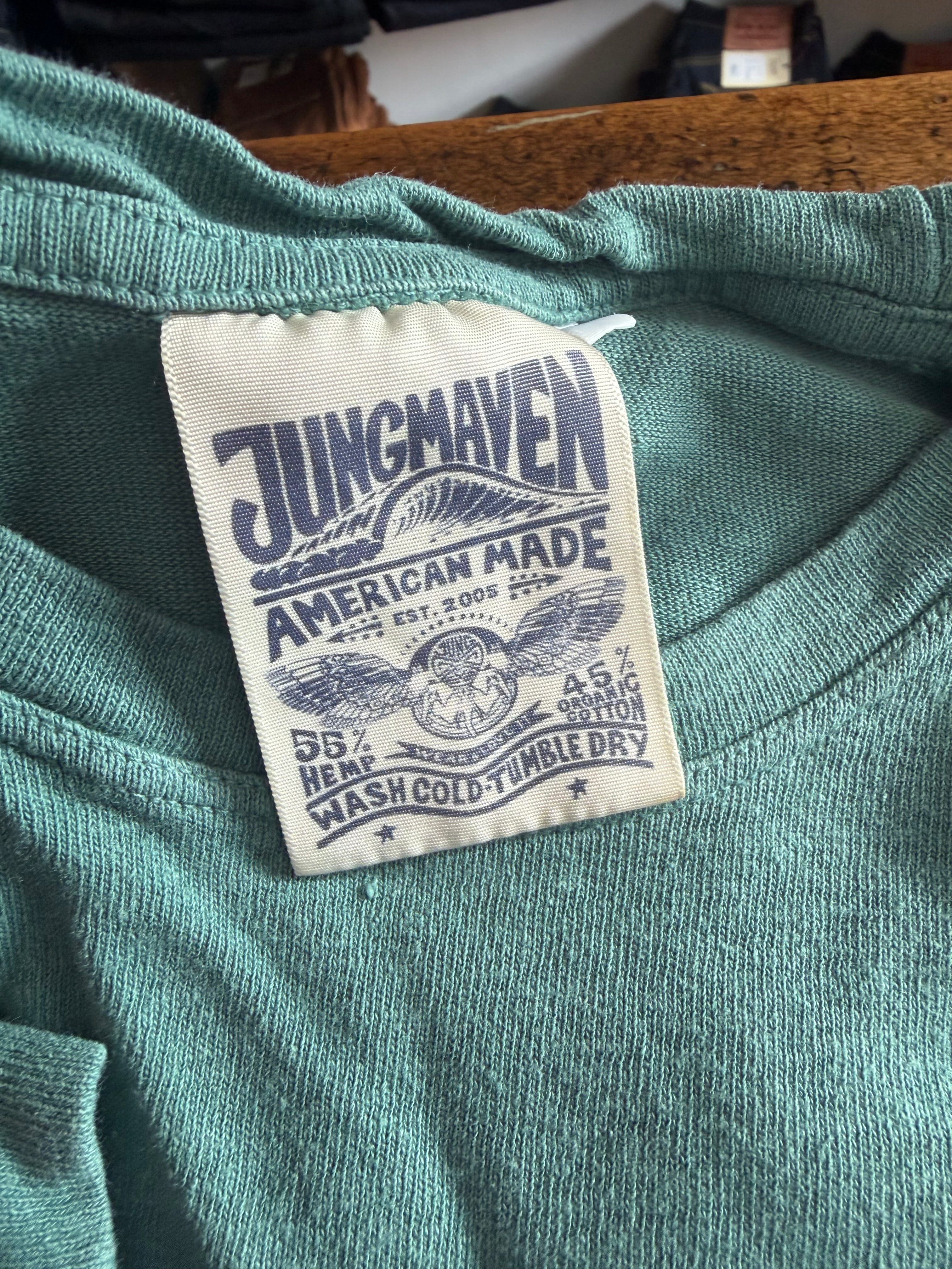Close-up of Jungmaven shirt tag, showing fabric texture and care details on inside neck.