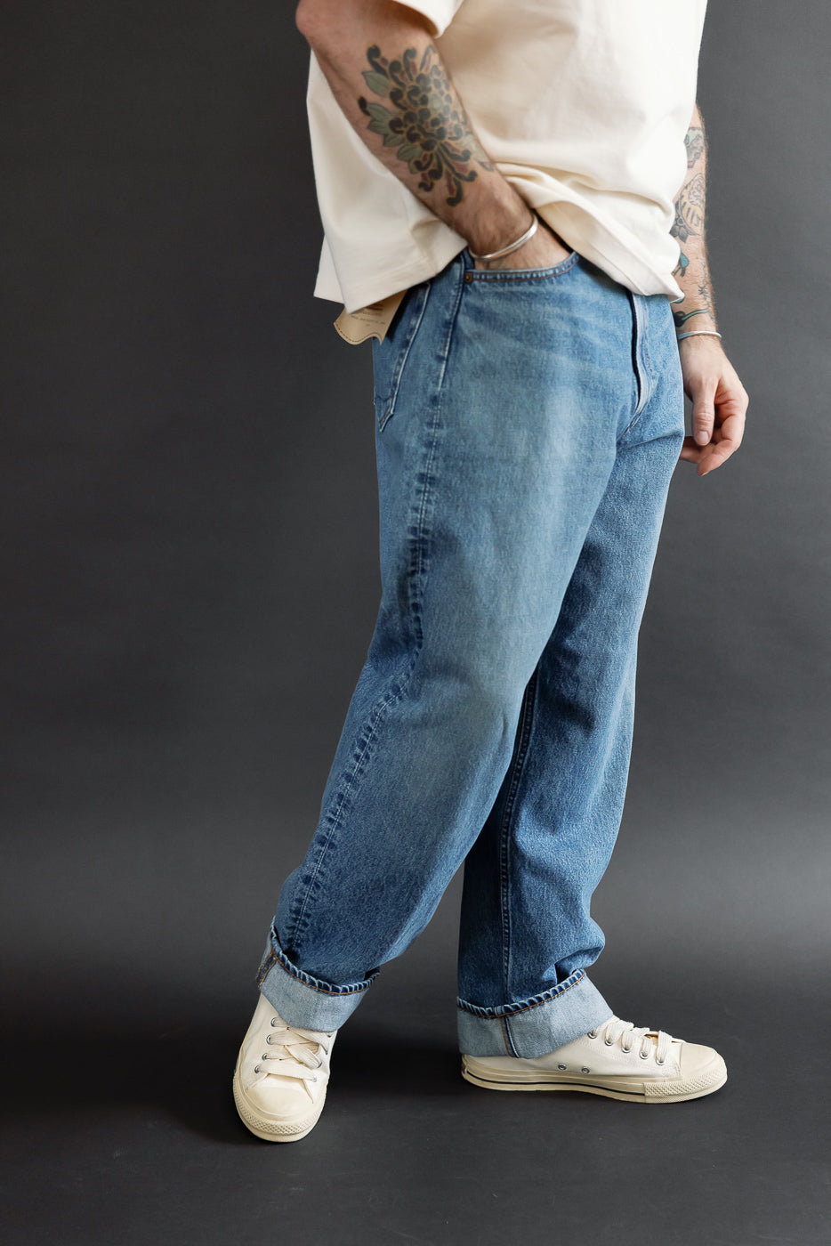 Side view of blue jeans on male model, 5'9