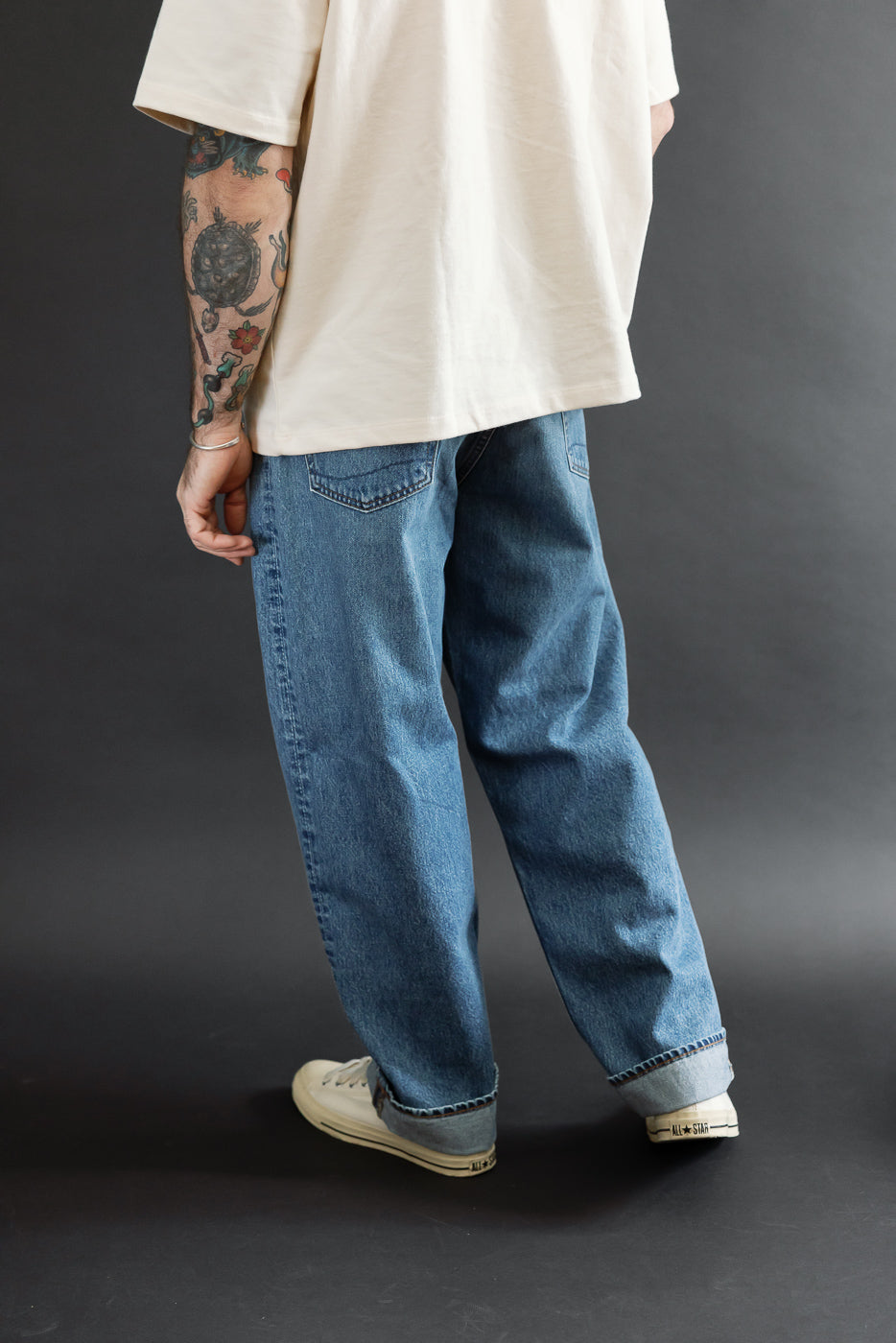 Back view of blue jeans on a male model, 5'9