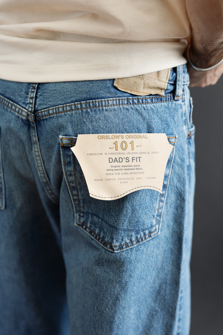 Close-up back view of light wash denim jeans featuring an Orslow's Original 101 Dad's Fit patch.