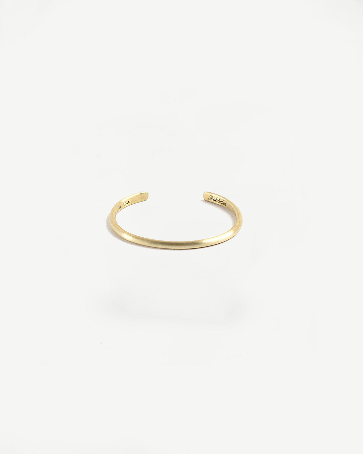 Close-up front view of Dant brushed brass cuff bracelet accessory on white background