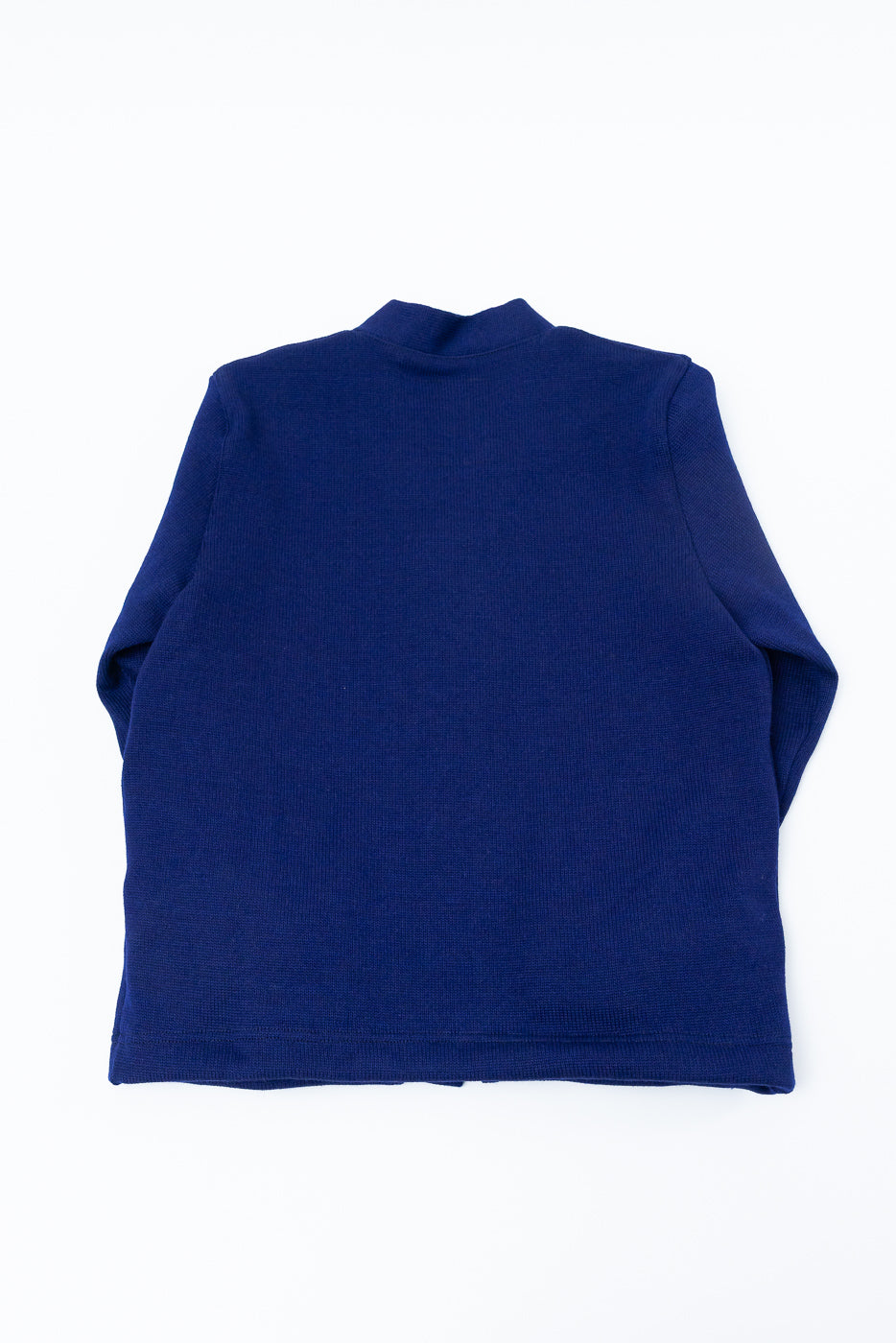 Flat lay of classic purple cardigan, back view showing long sleeves and knit fabric texture.