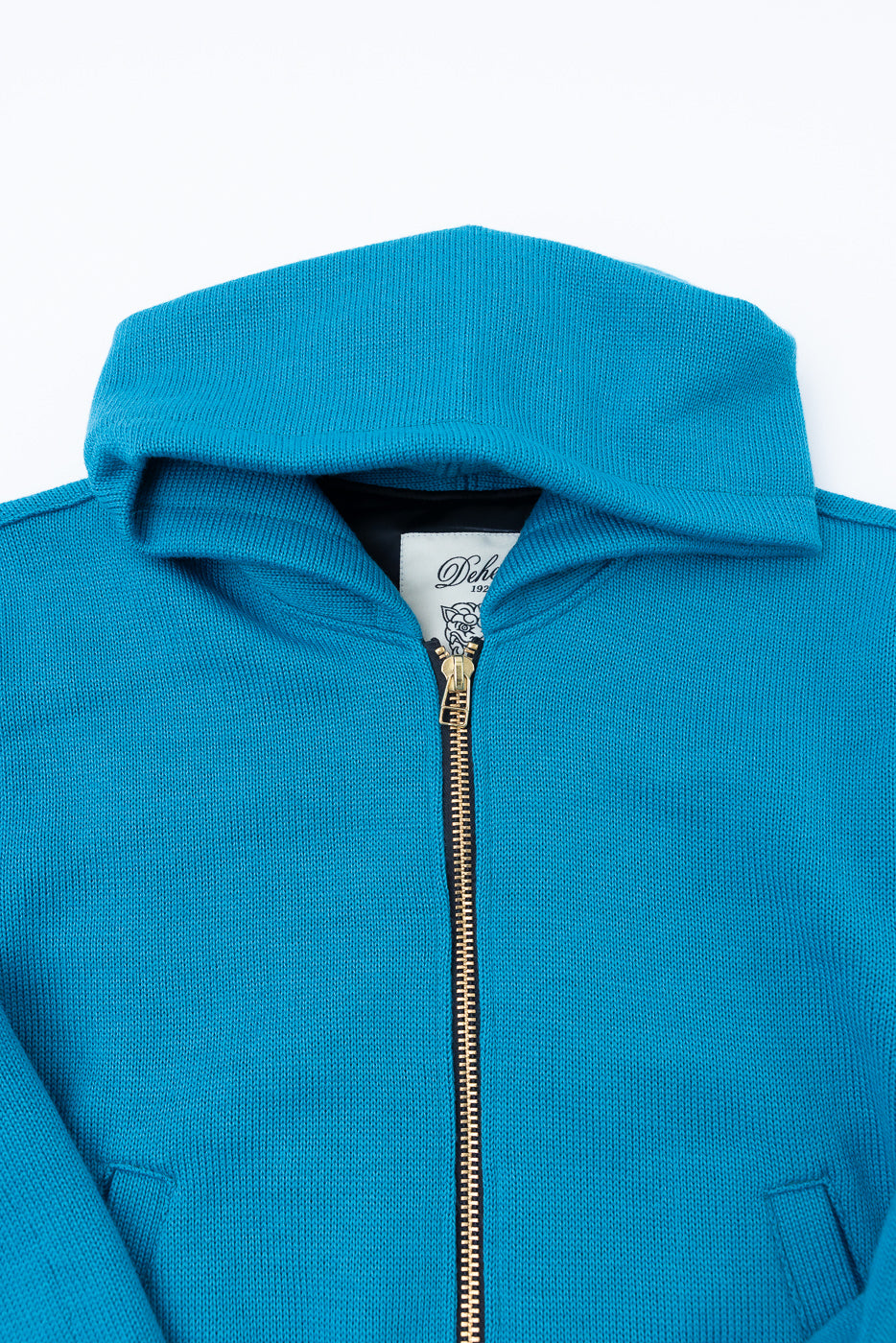 Close-up of aqua full-zip moto hoodie front, showing hood, zipper, knit texture, and chest area.