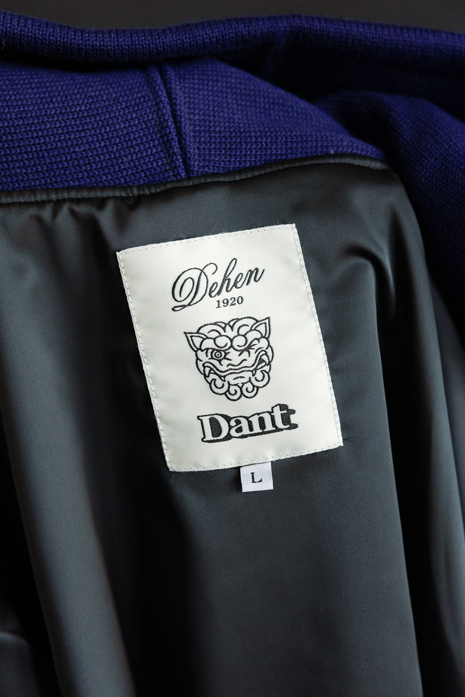 Close-up of the inside neck area of a purple moto hoodie showing the sewn interior label.