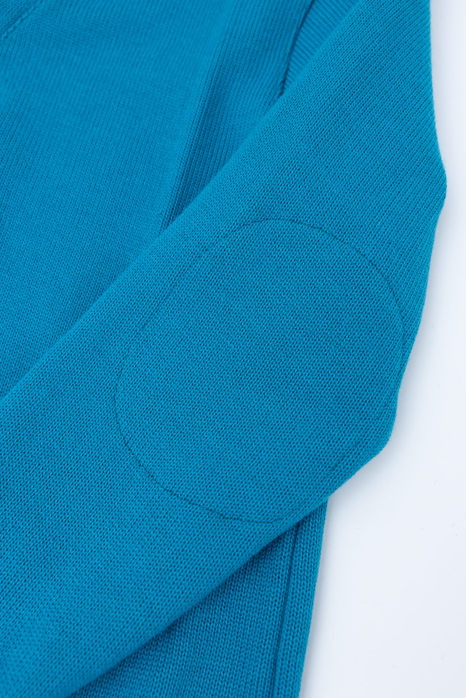 Close-up of aqua blue shawl sweater coat sleeve with reinforced elbow patch, left side.